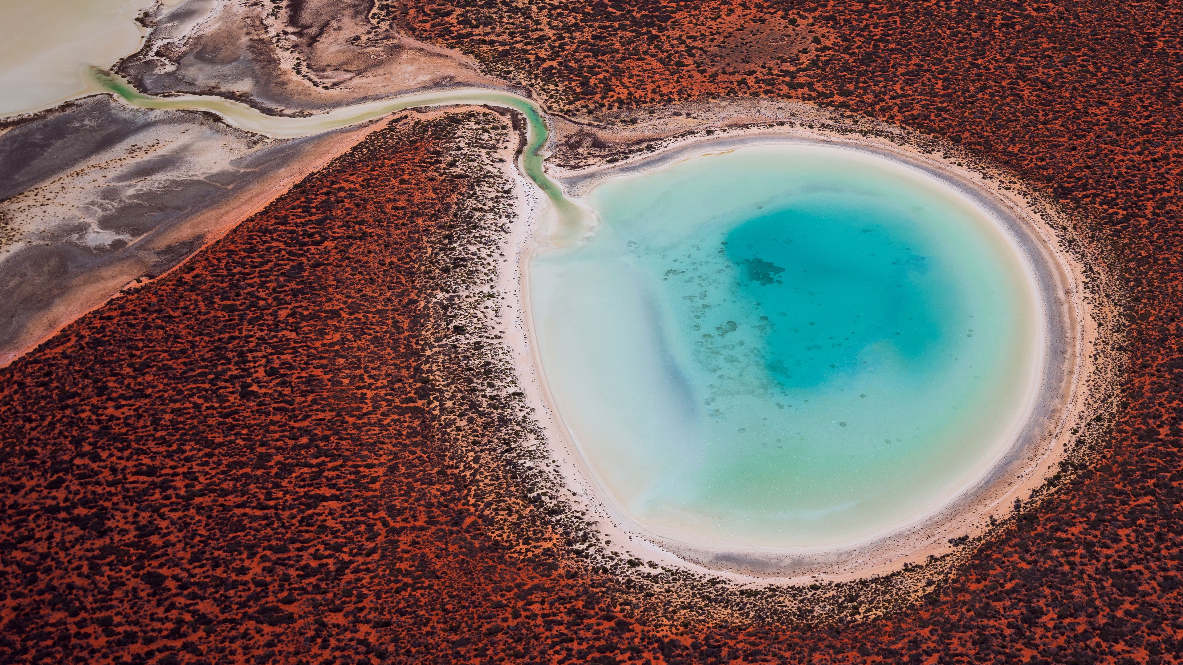 Stunning Landscapes: Red Dunes Meet Blue Lagoons