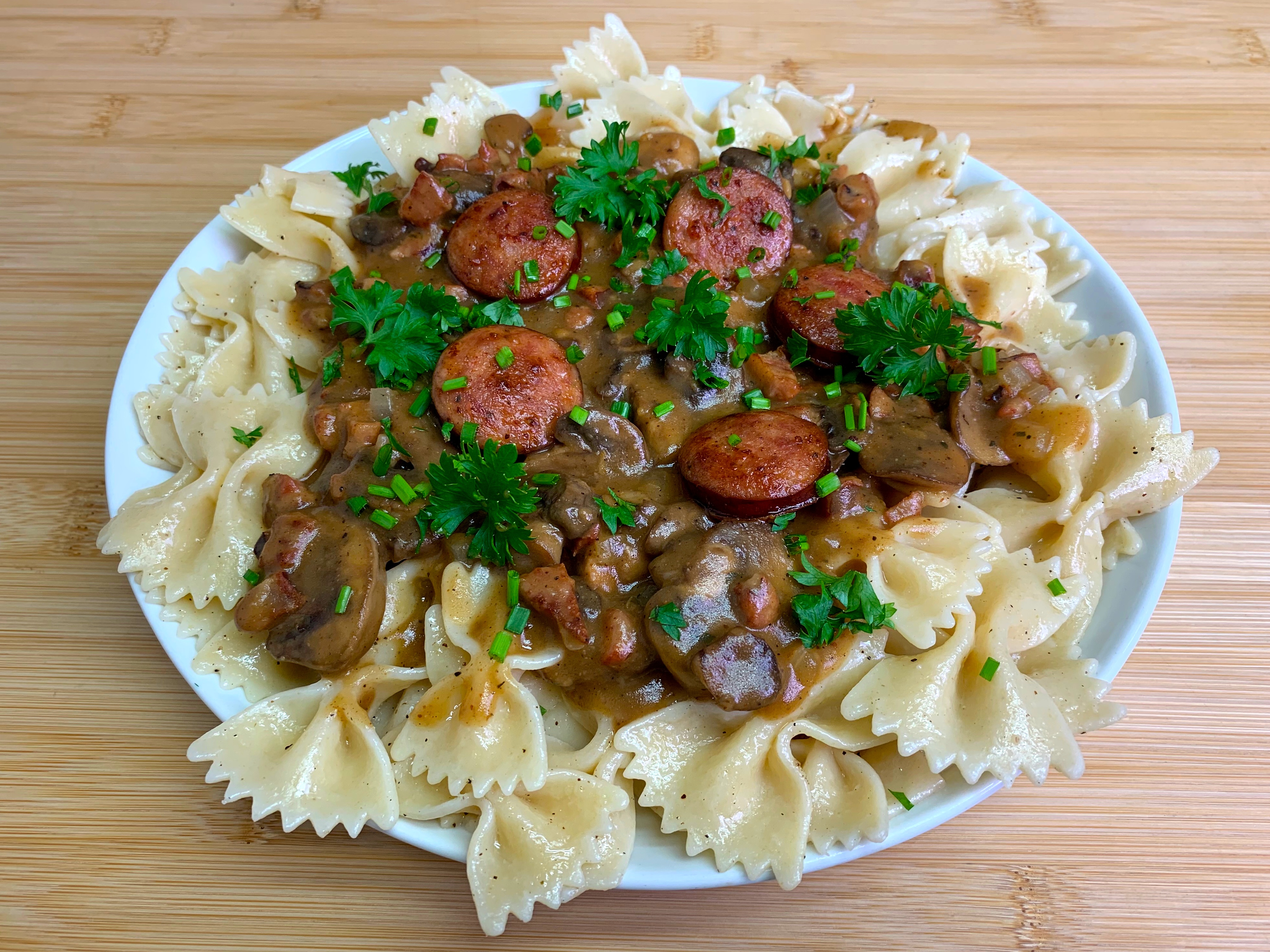 Indulge in Spicy Debreziner Sausage with Paprika Mushroom Sauce Over Buttered Farfalle