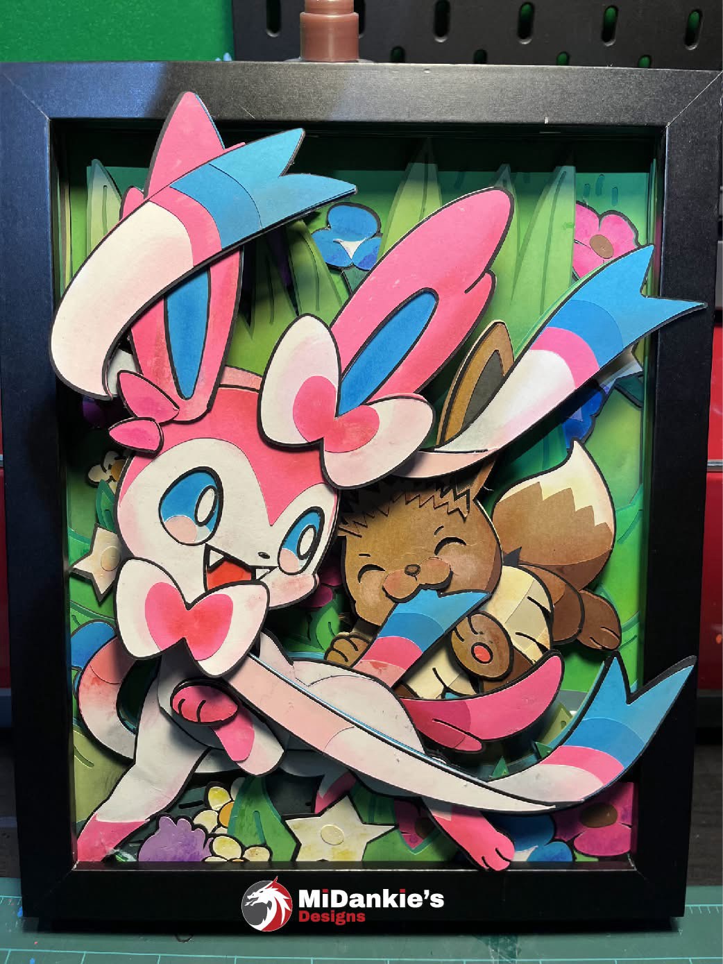 A charming shadow box featuring Sylveon and Eevee!