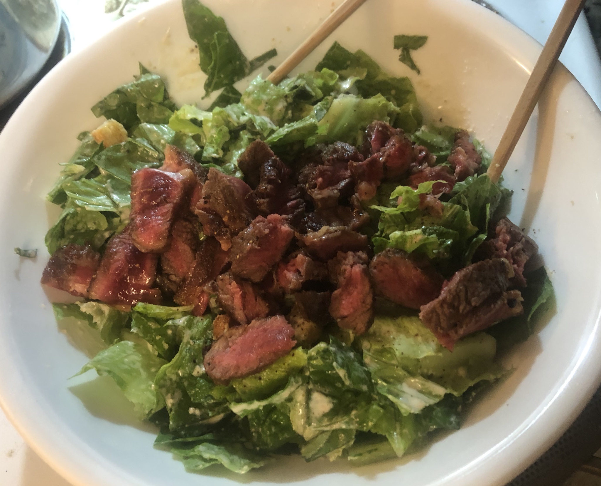 Indulging in Steak and Caesar Salad Delight