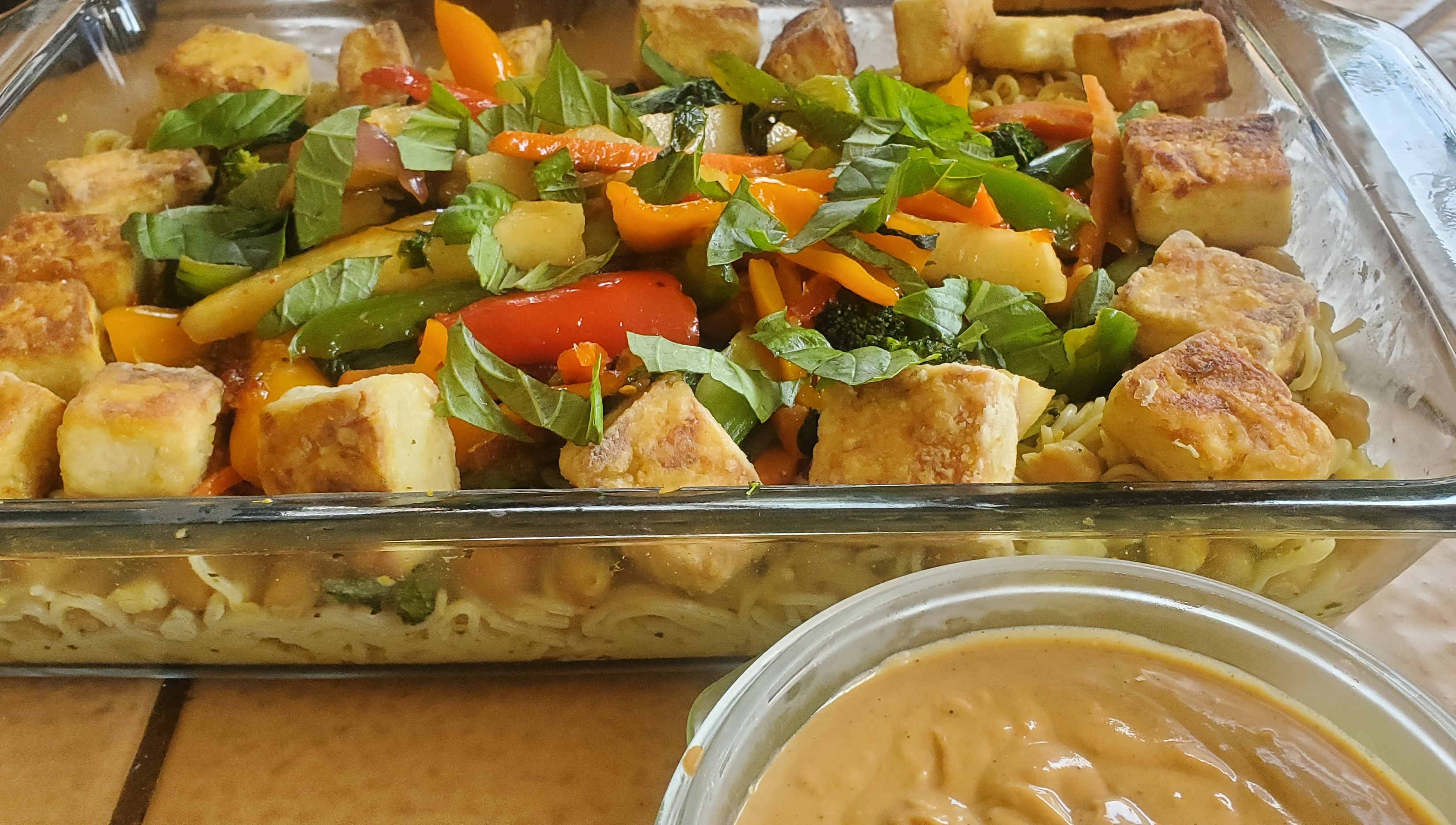 Savoring Green Curry Coconut Sauce with Brown Rice Noodles, Garbanzos, Veggies, Cashews, and Tofu