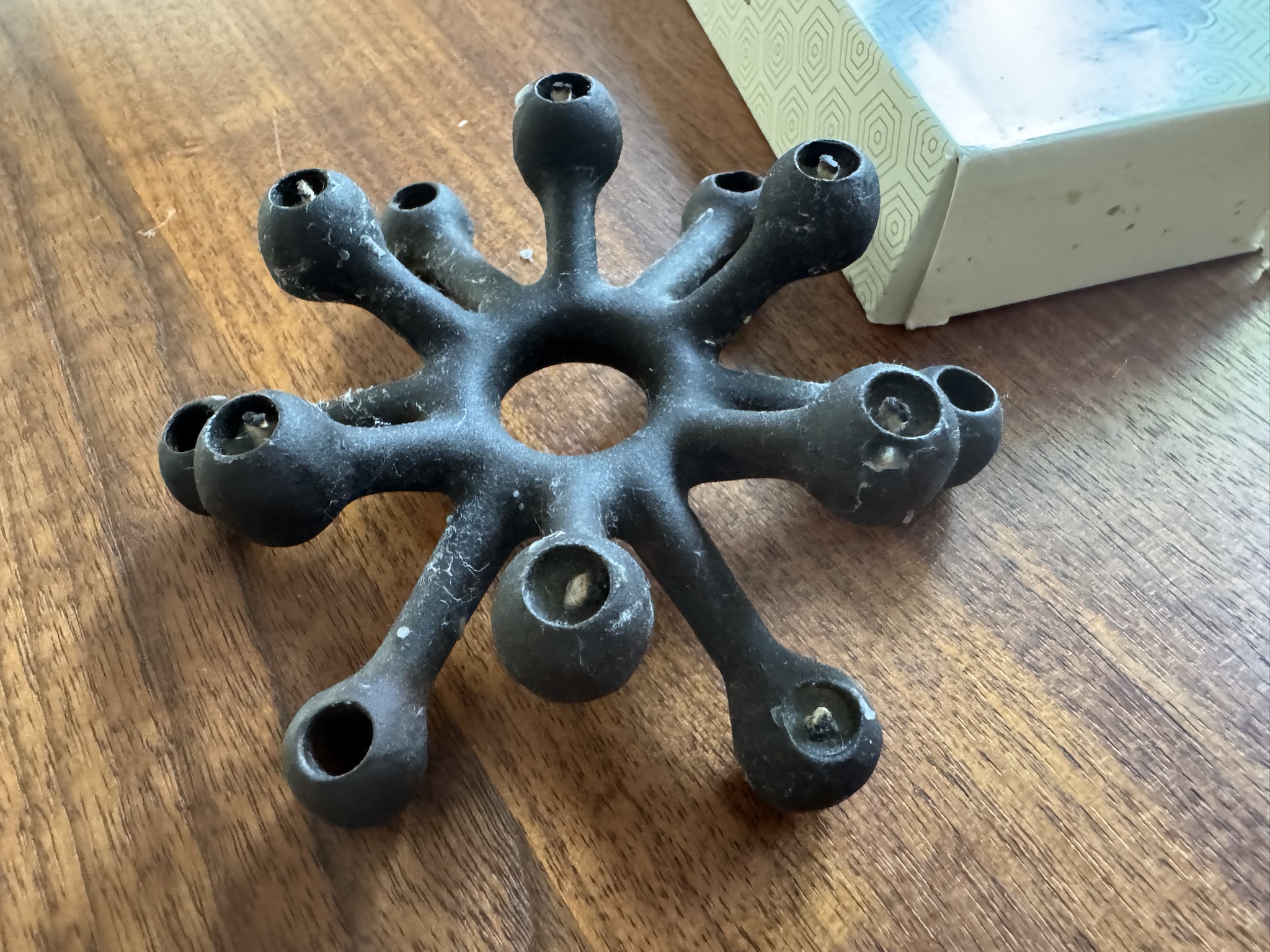 What’s the best way to remove wax from an old cast iron candle holder with tiny holes?