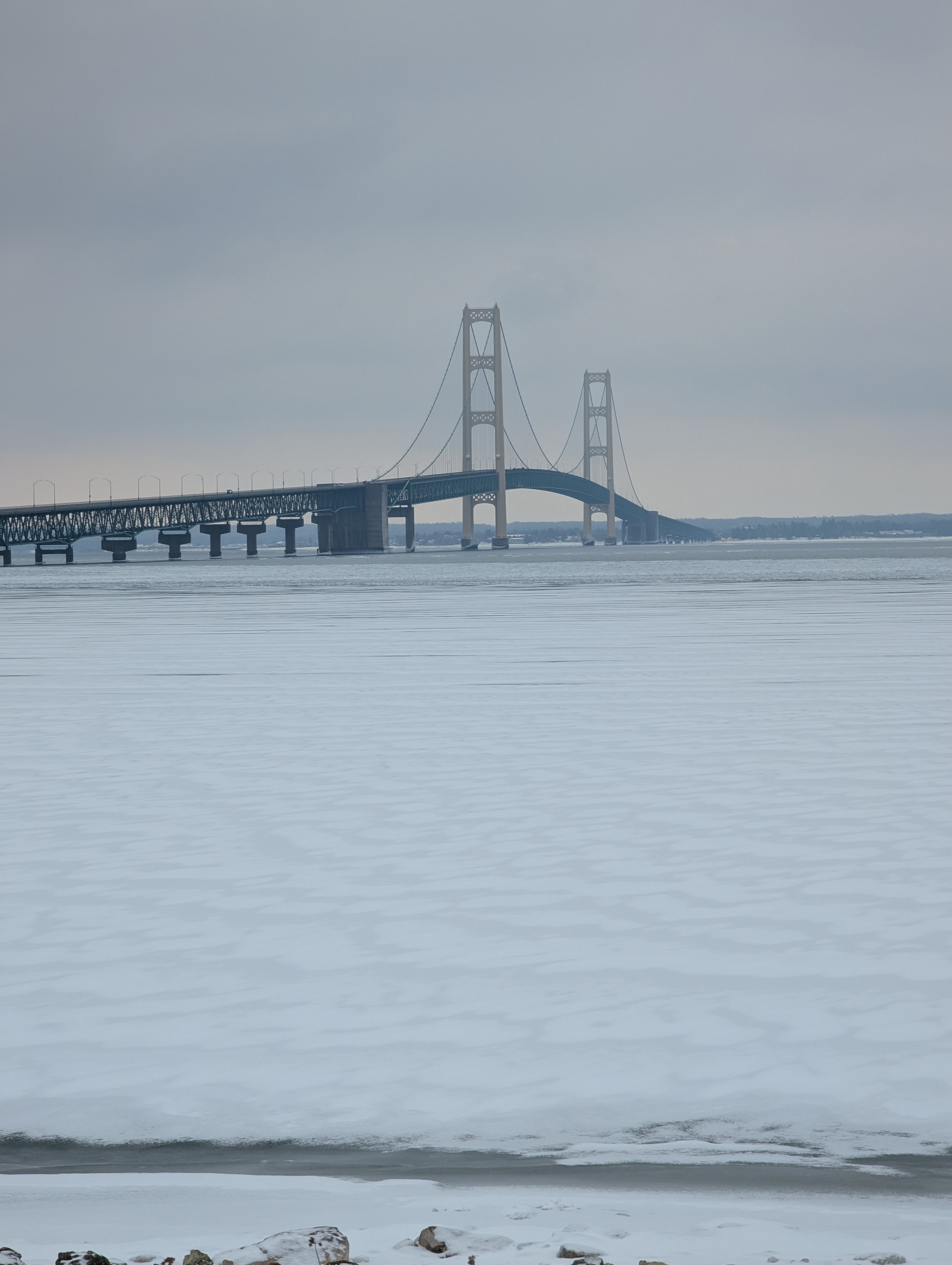 A boat, a bridge, and some train tracks