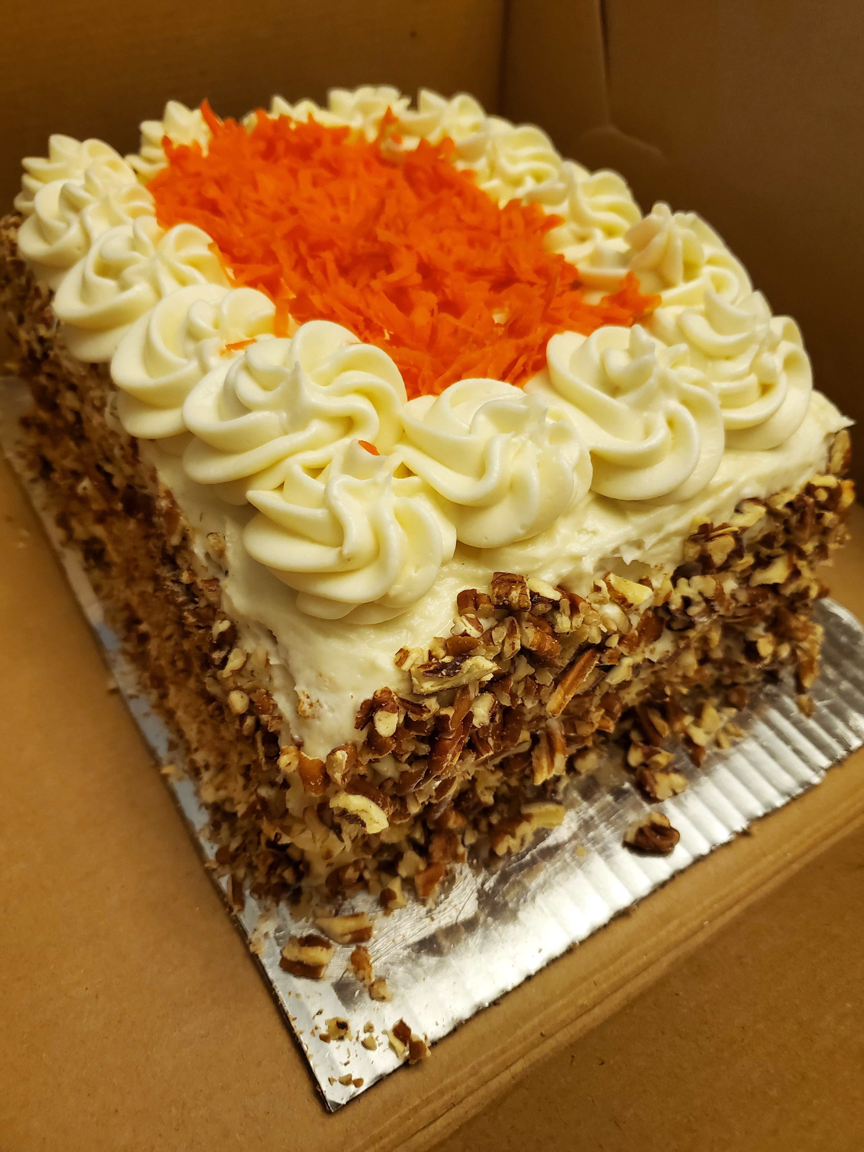Delicious Carrot Layer Cake Topped with Toasted Pecans and Cream Cheese Frosting!