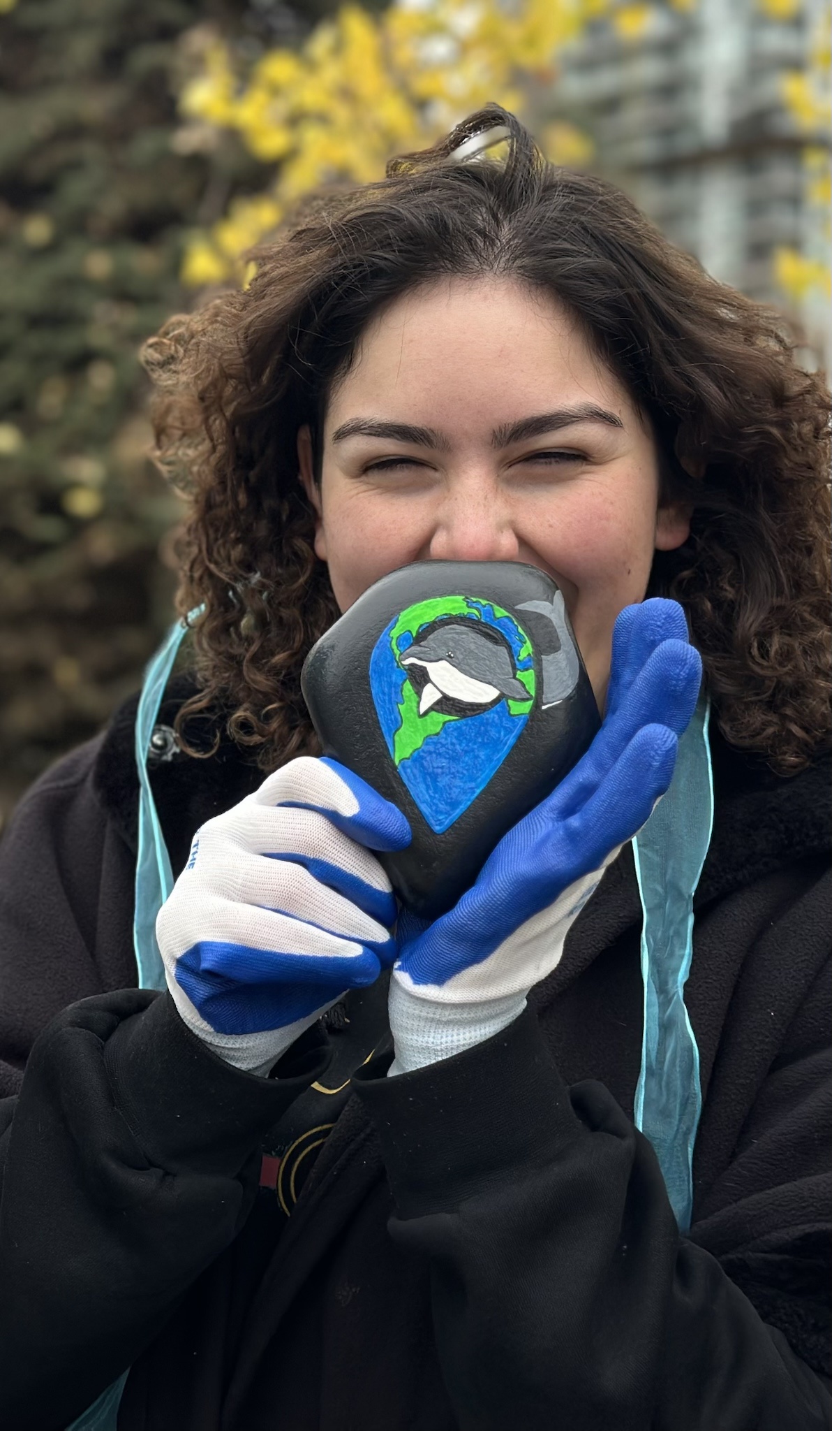 A close-up of a thoughtful gift featuring the Keep The Earth Fresh logo on a kindness rock.