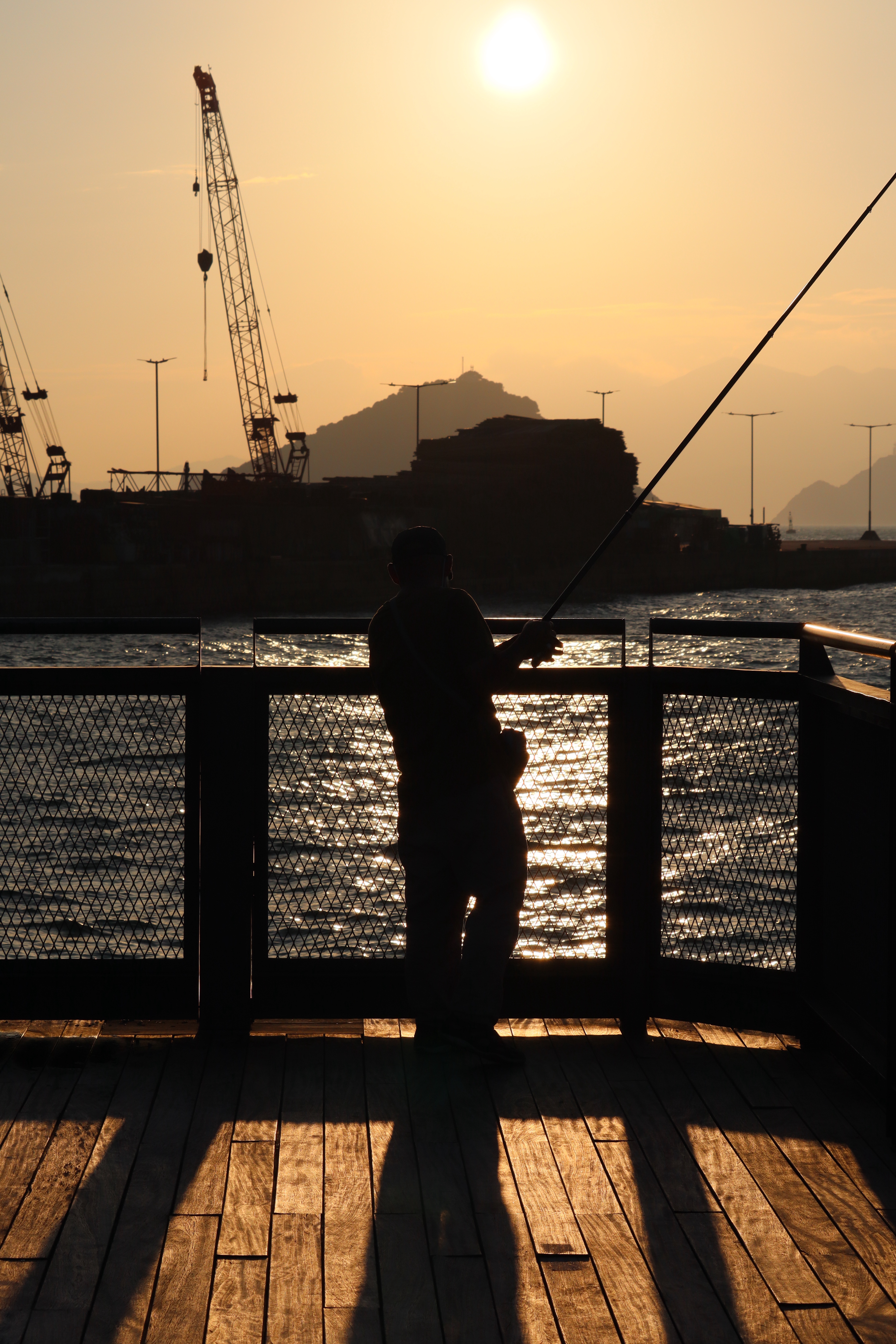 An Old Man Enjoying a Peaceful Day Fishing in Hong Kong