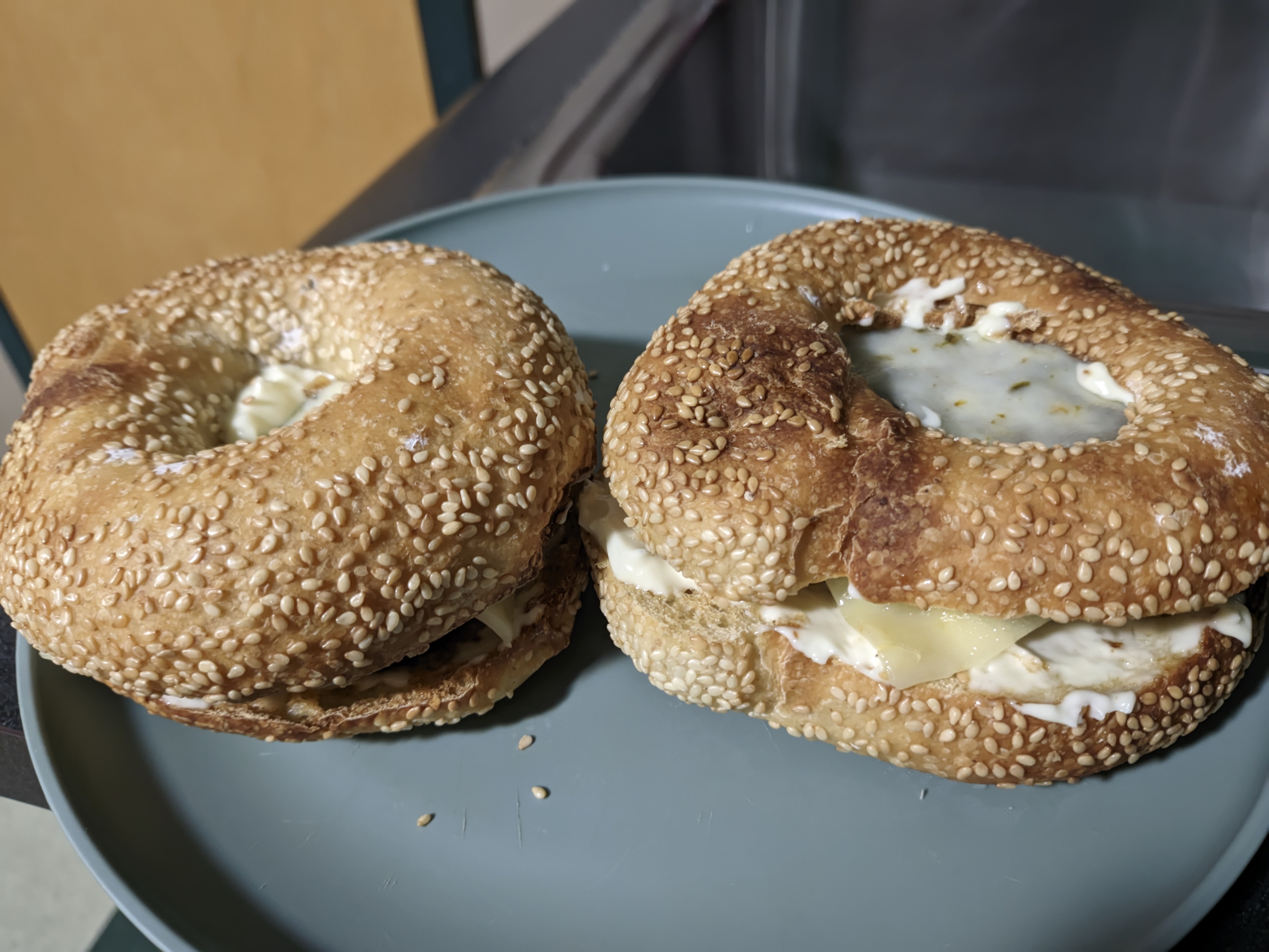 Indulge in a toasted sesame seed bagel burger topped with pepper jack cheese!