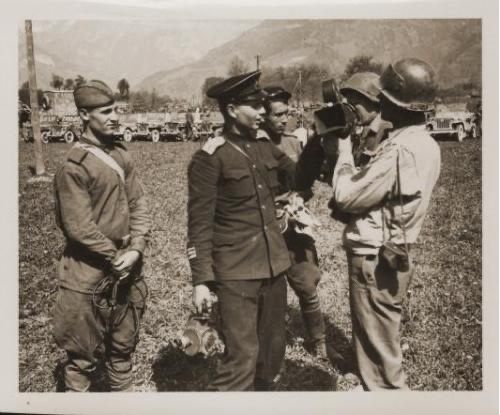 American soldiers share their film camera with Soviet troops after the historic link-up near Steyr, Austria.