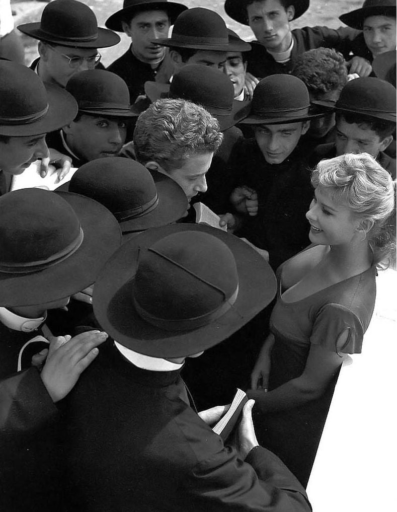 Actress Marisa Allasio surrounded by seminarians in 1955