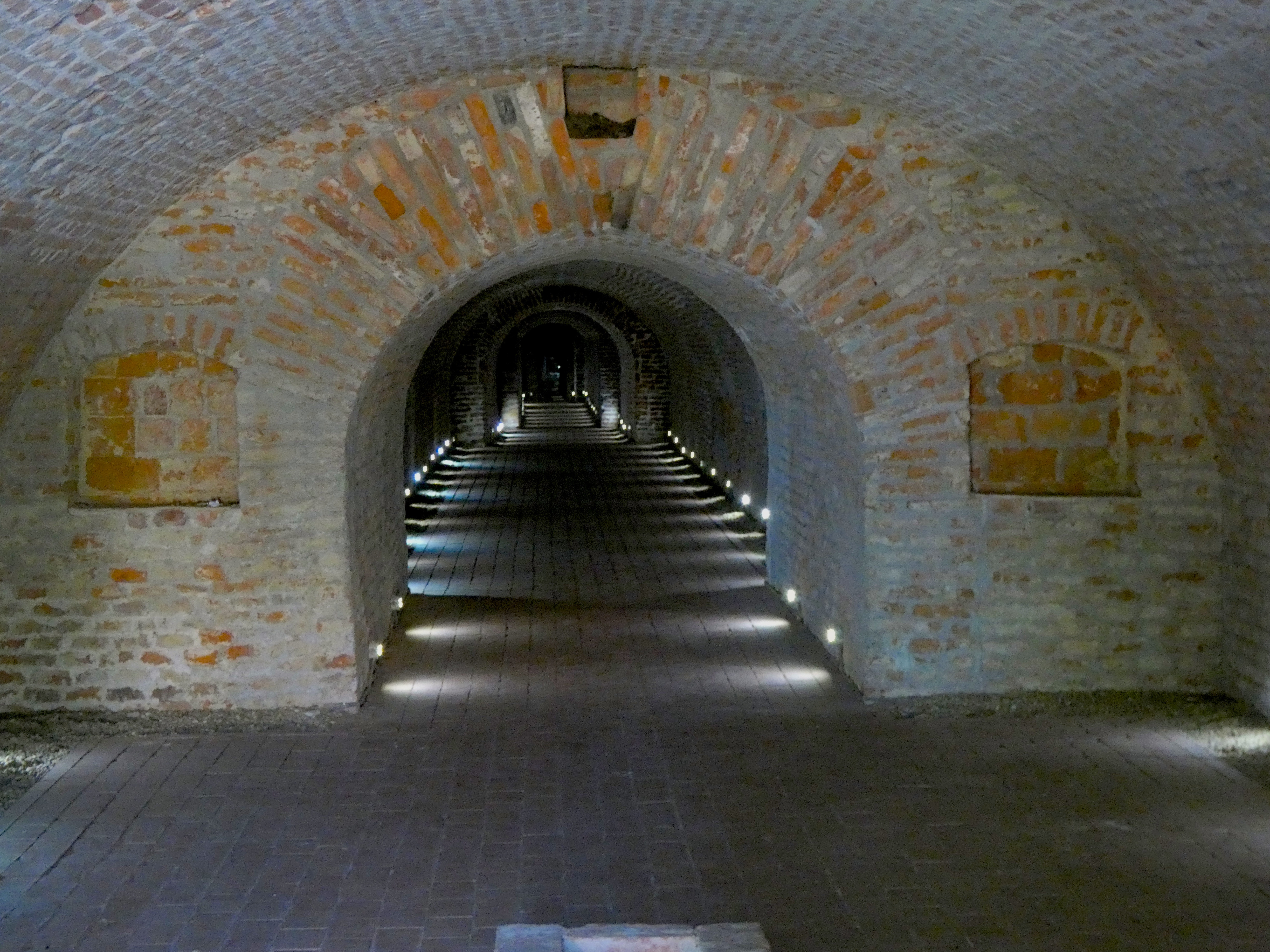 Explore the Enigmatic Brick Tunnels Illuminated by Soft Lights Leading into Mystery