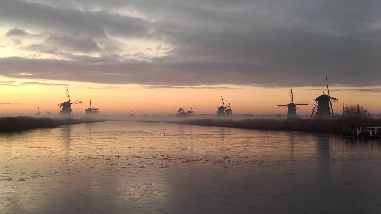 Misty Windmills of Kinderdijk: A Serene Landscape