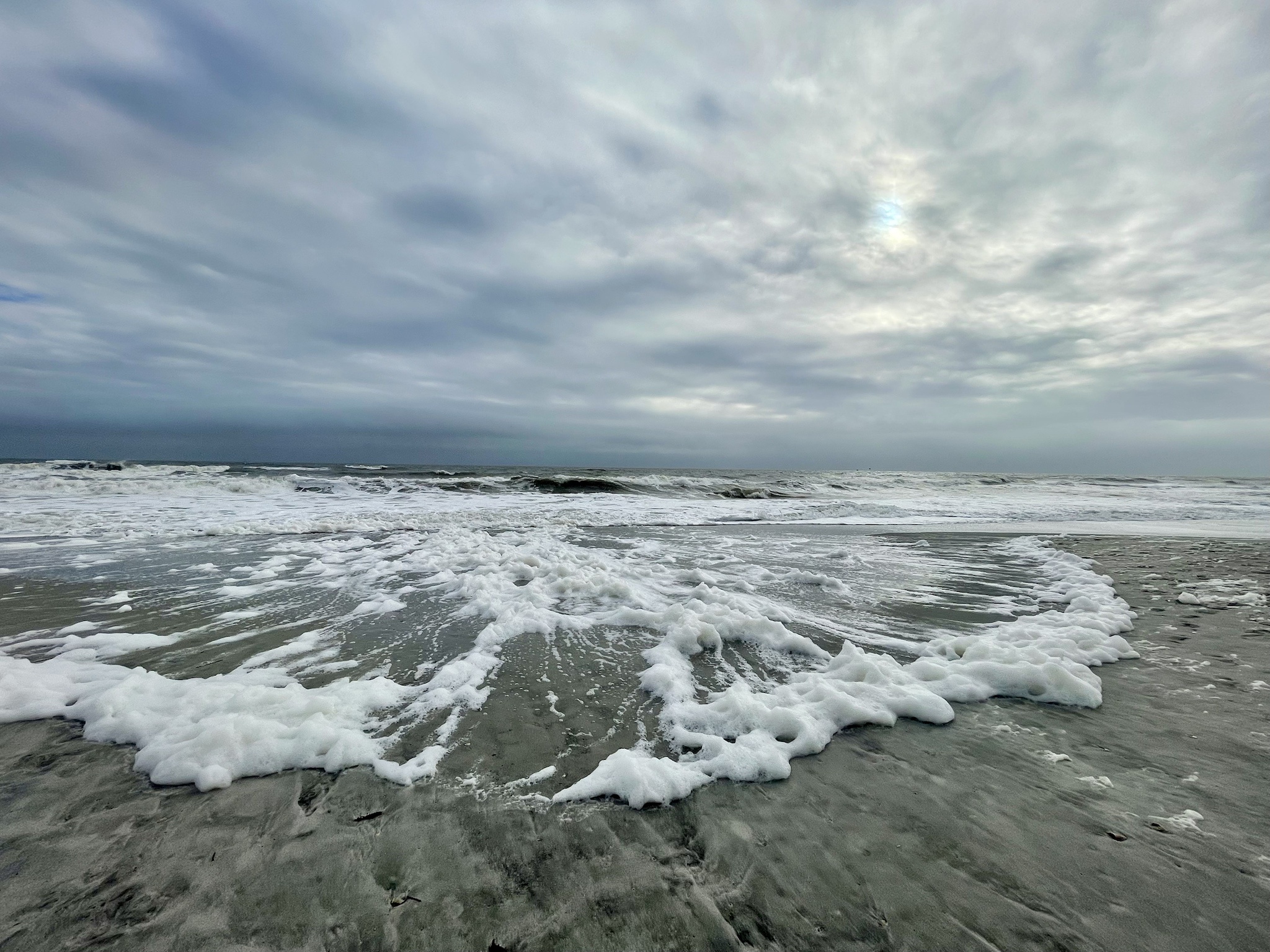 A Windy Morning Stroll on the Foamy Beach