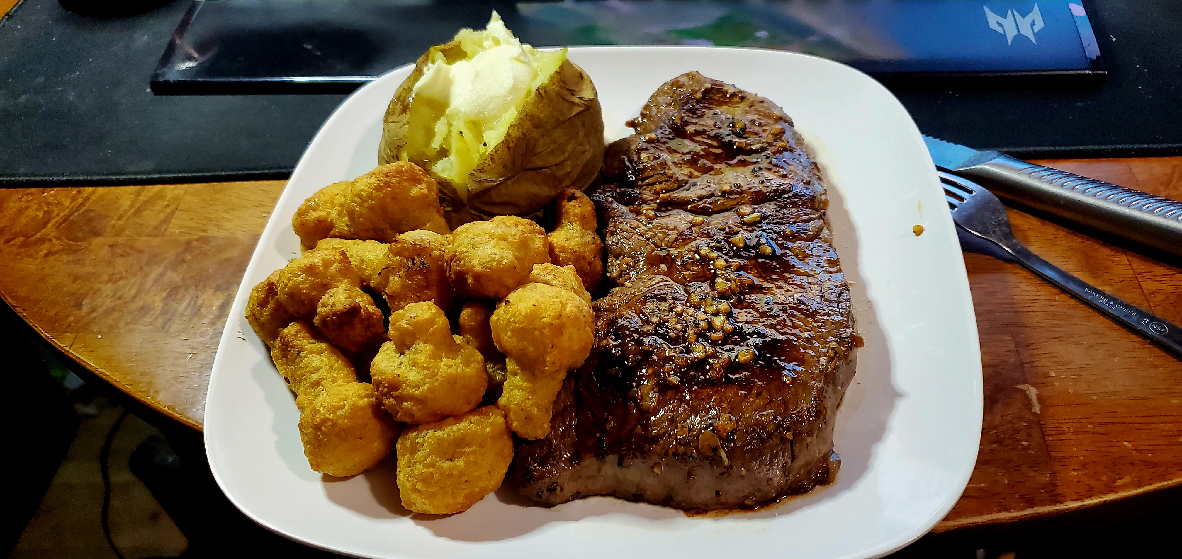 Last night's dinner was a feast: deep-fried mushrooms, a baked potato, and a perfectly rare steak!