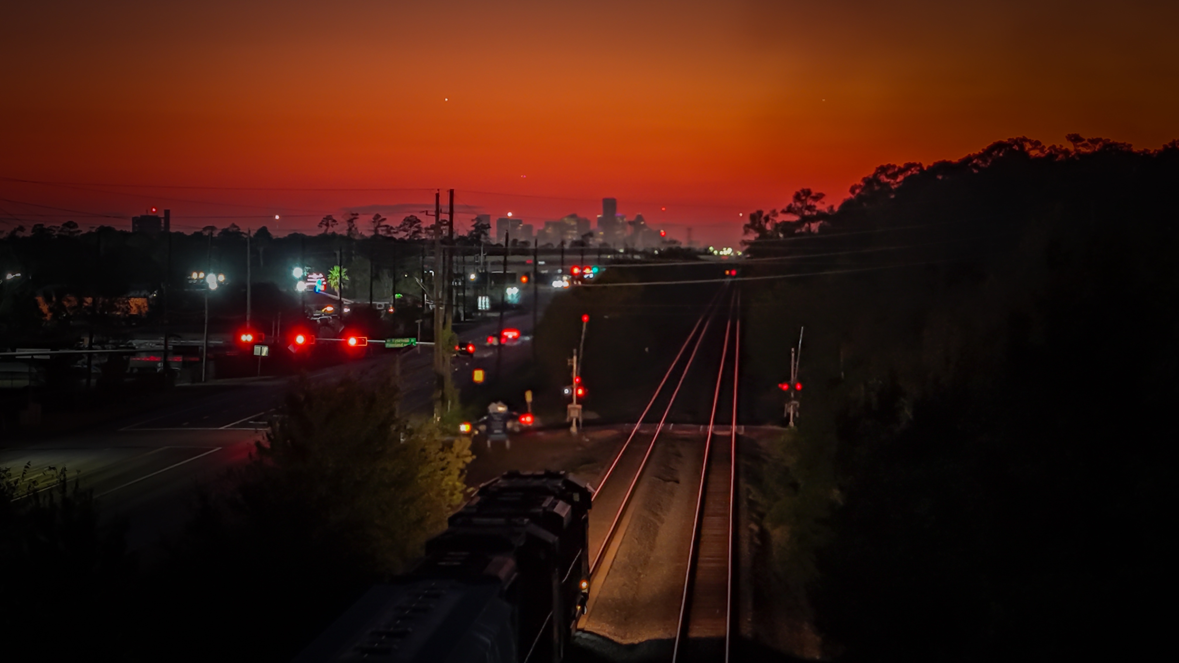A breathtaking view of trains against a stunning sunset.