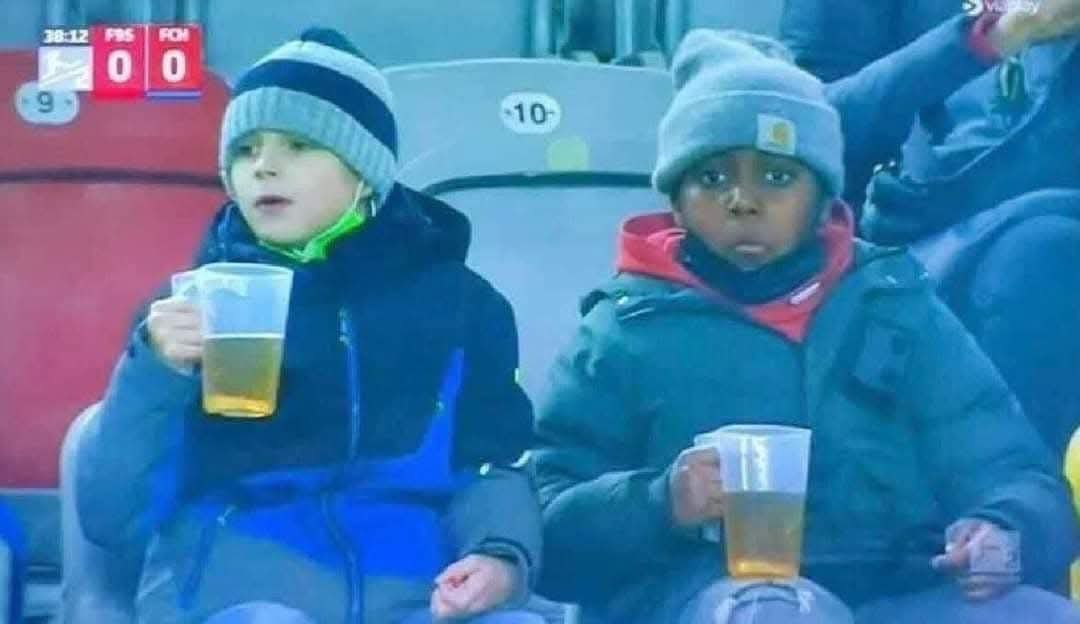 Two kids savoring life without screens, sharing a cold beer and making memories.