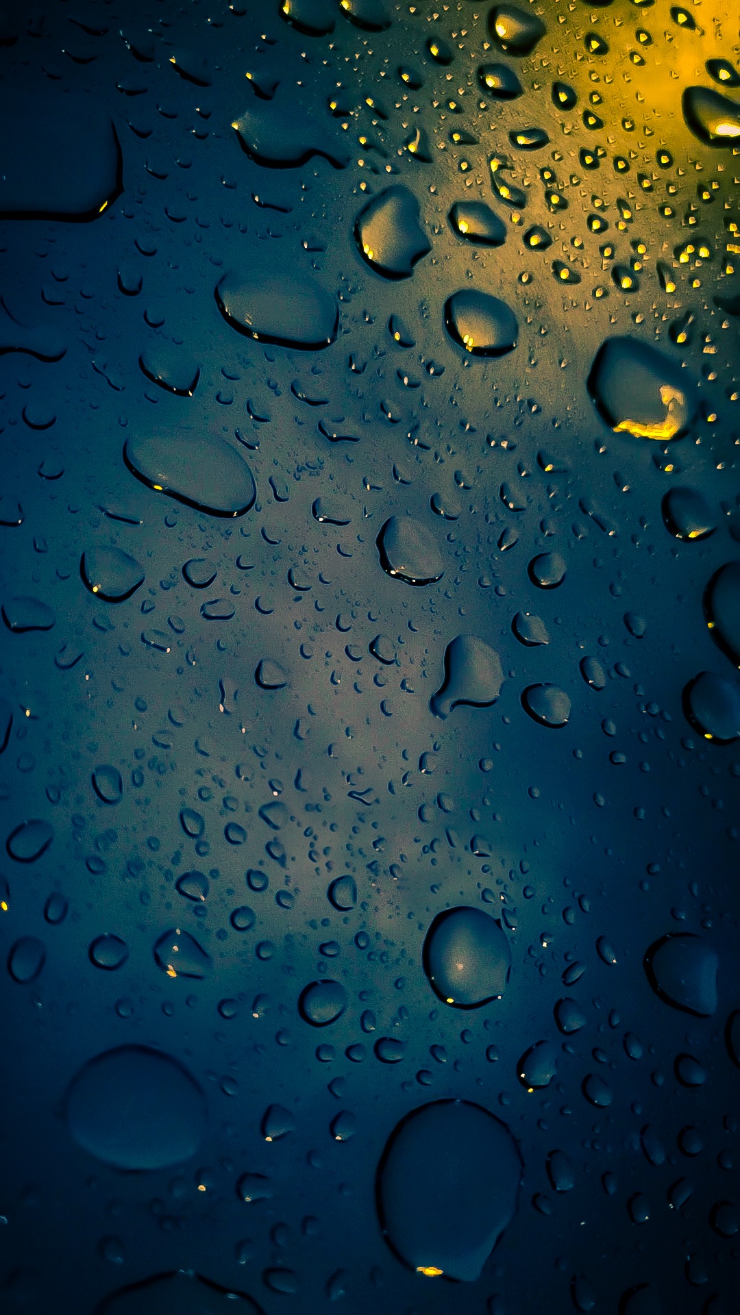 Raindrops dancing on my car hood.