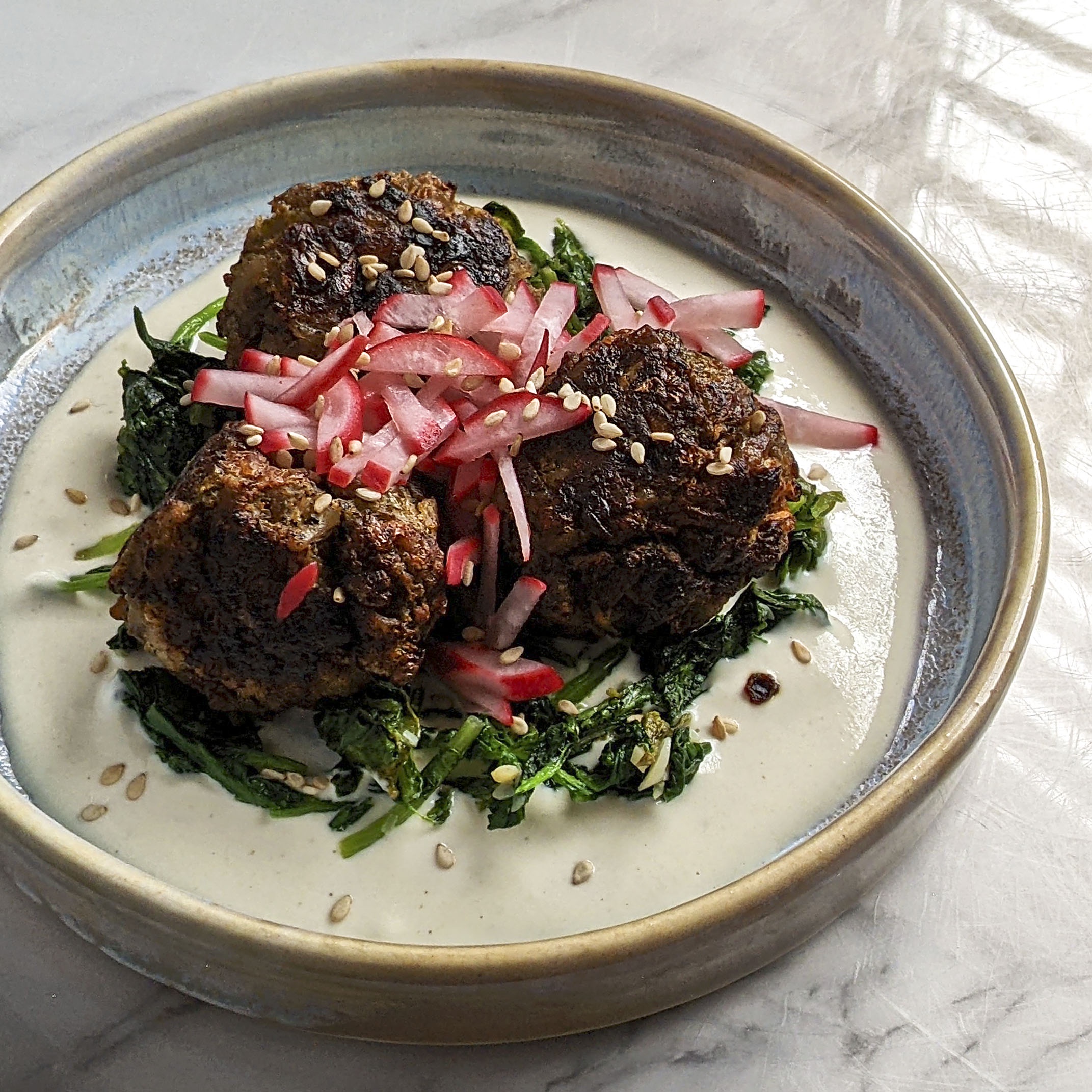 Deliciously Unique: Beef and Green Cabbage Meatballs with Garlic Radish Greens and Tahini Yogurt