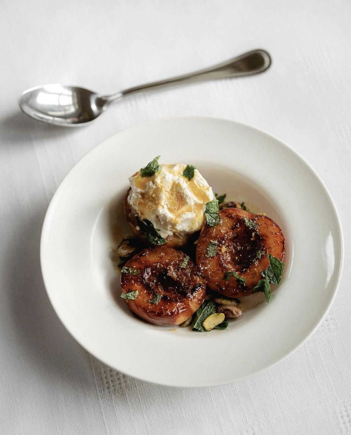 Is food a form of art? Check out these fried brown butter peaches topped with mint, citrus whiskey syrup, and mascarpone!