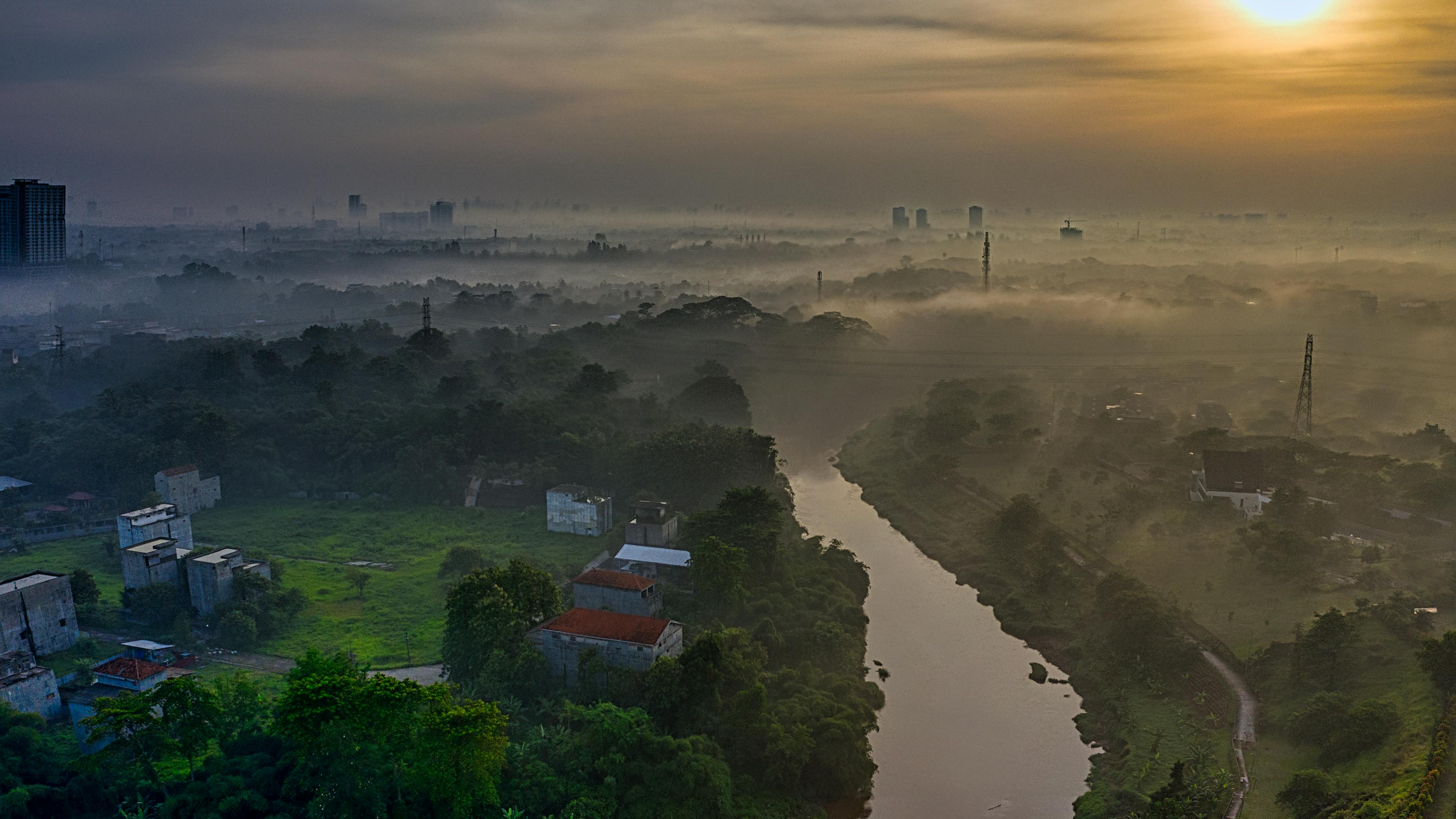 Breathtaking morning mist over the winding river.