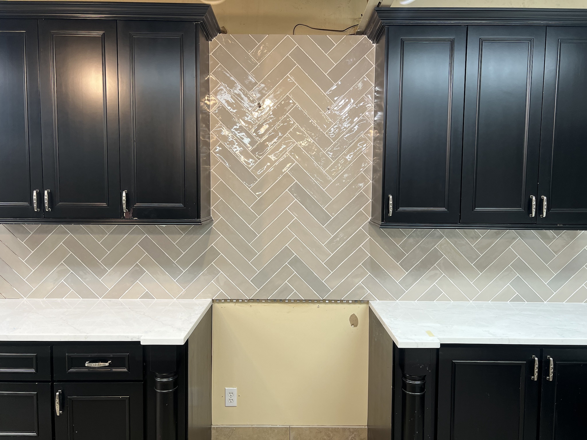 Stunning diagonal herringbone backsplash design.