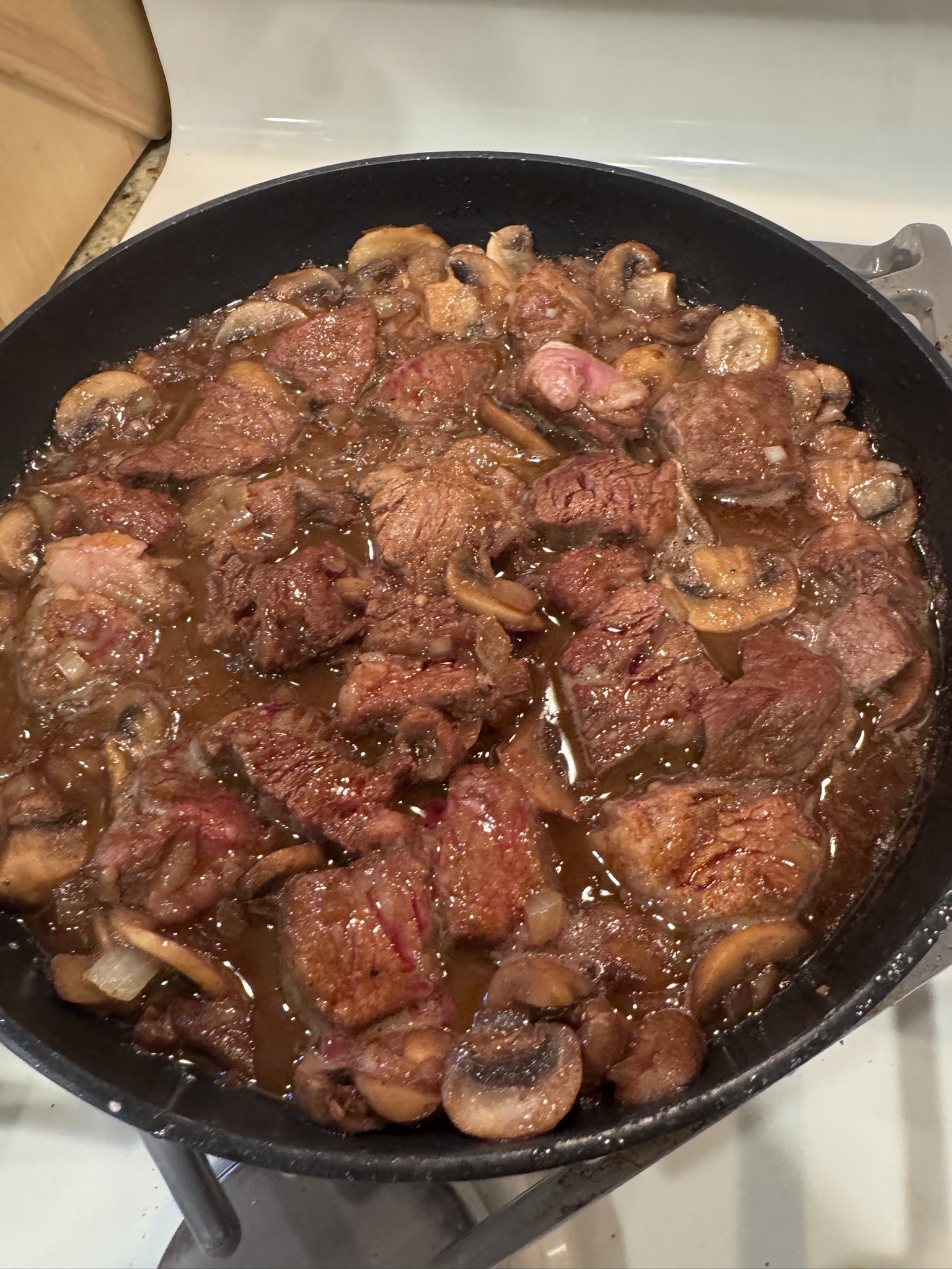 Indulge in Kevin's Savory Garlic Butter Steak Bites with Mushrooms and Onions, Drizzled with a Rich Pan Sauce