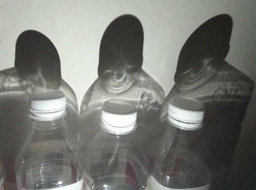 Eerie Shadows Cast by Water Bottles