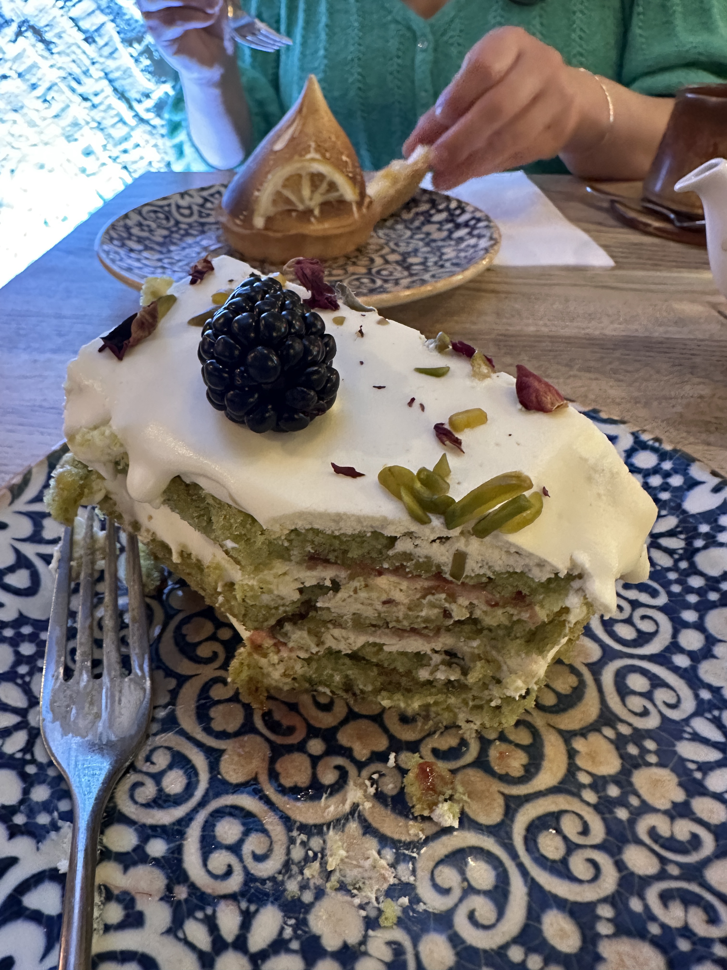 Delicious pistachio and rose cake with lemon meringue lurking in the background.