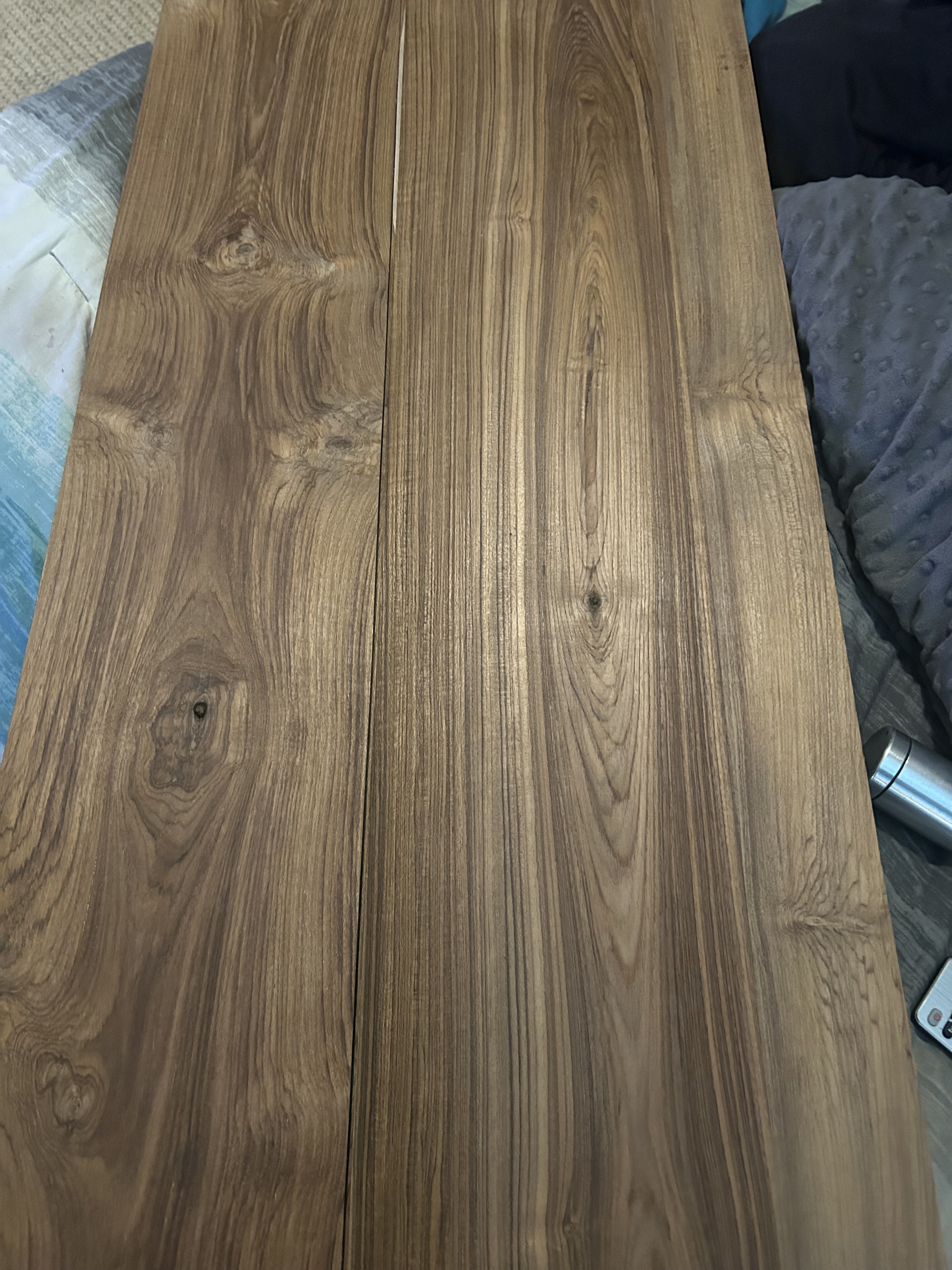 Can anyone identify this? It's a hefty piece of wood, definitely not walnut. My friend gifted me some shelves, and this was hidden beneath the paint.