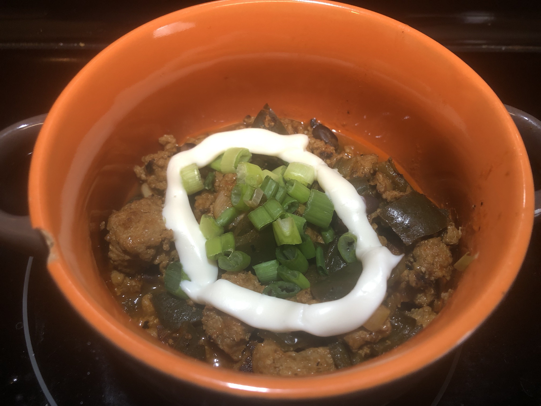 Delicious Weeknight Turkey Chili Topped with Cheese and Sour Cream