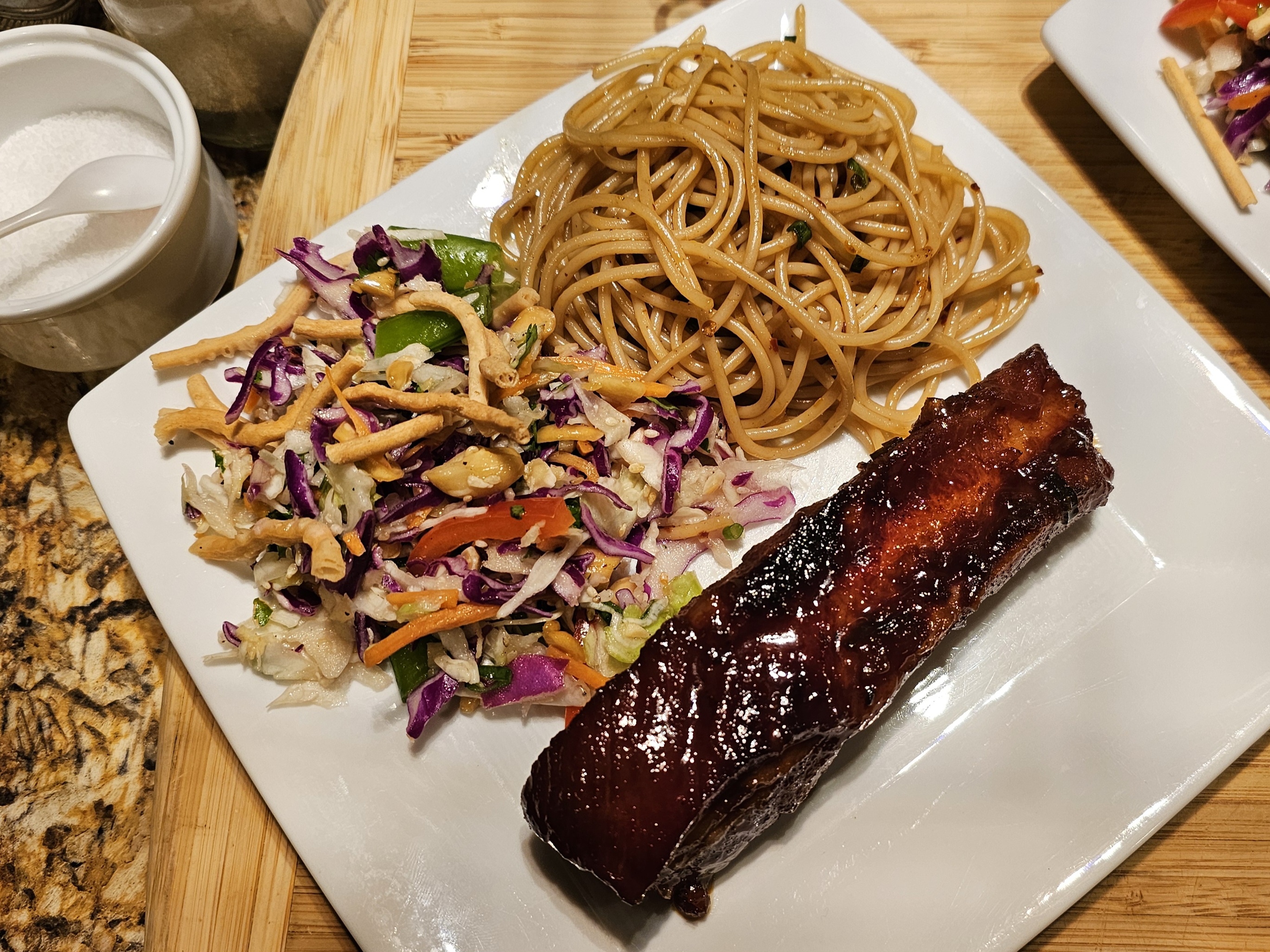 Deliciously caramelized pork spare ribs paired with cold noodles and a refreshing cabbage salad