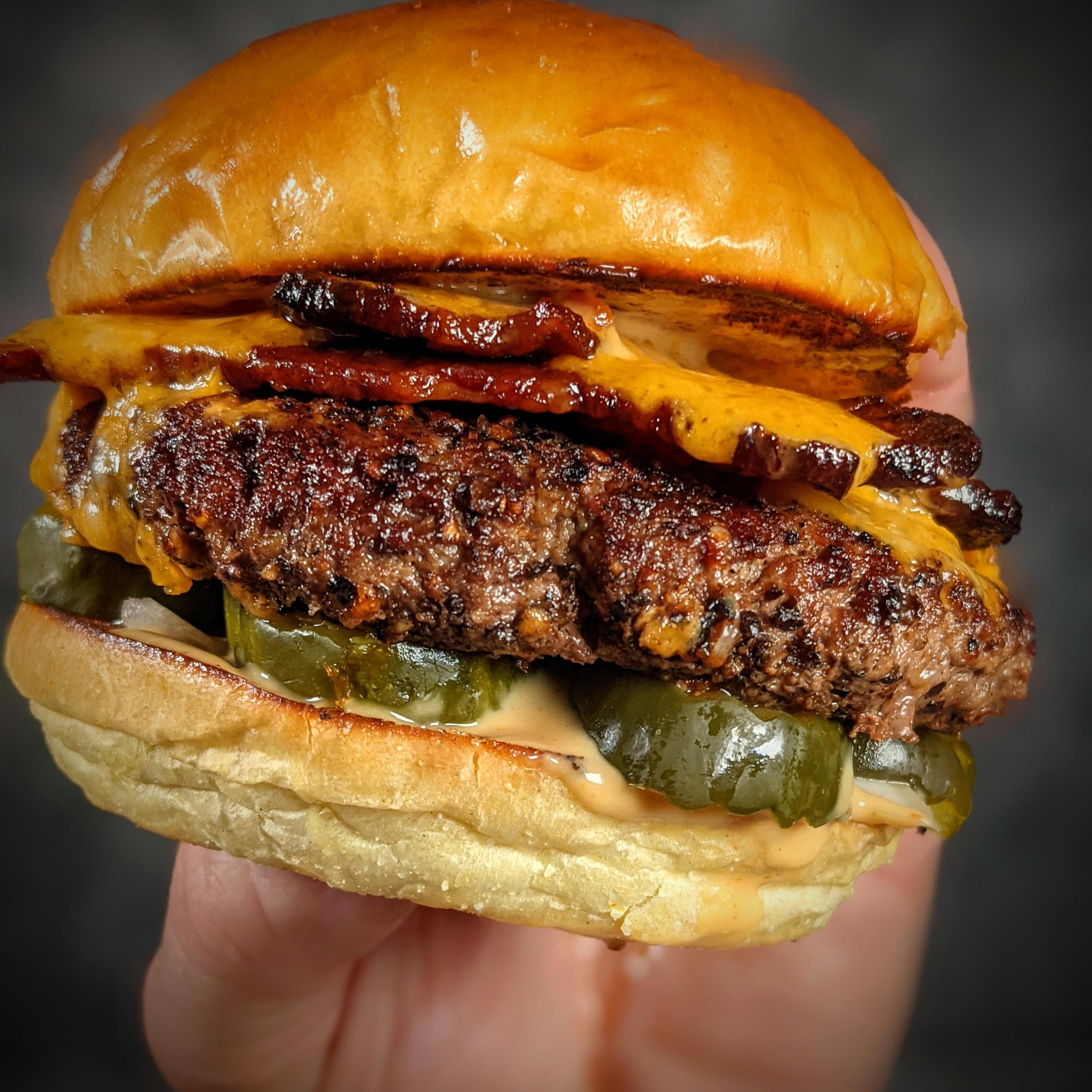 Indulging in a delicious bacon cheeseburger!