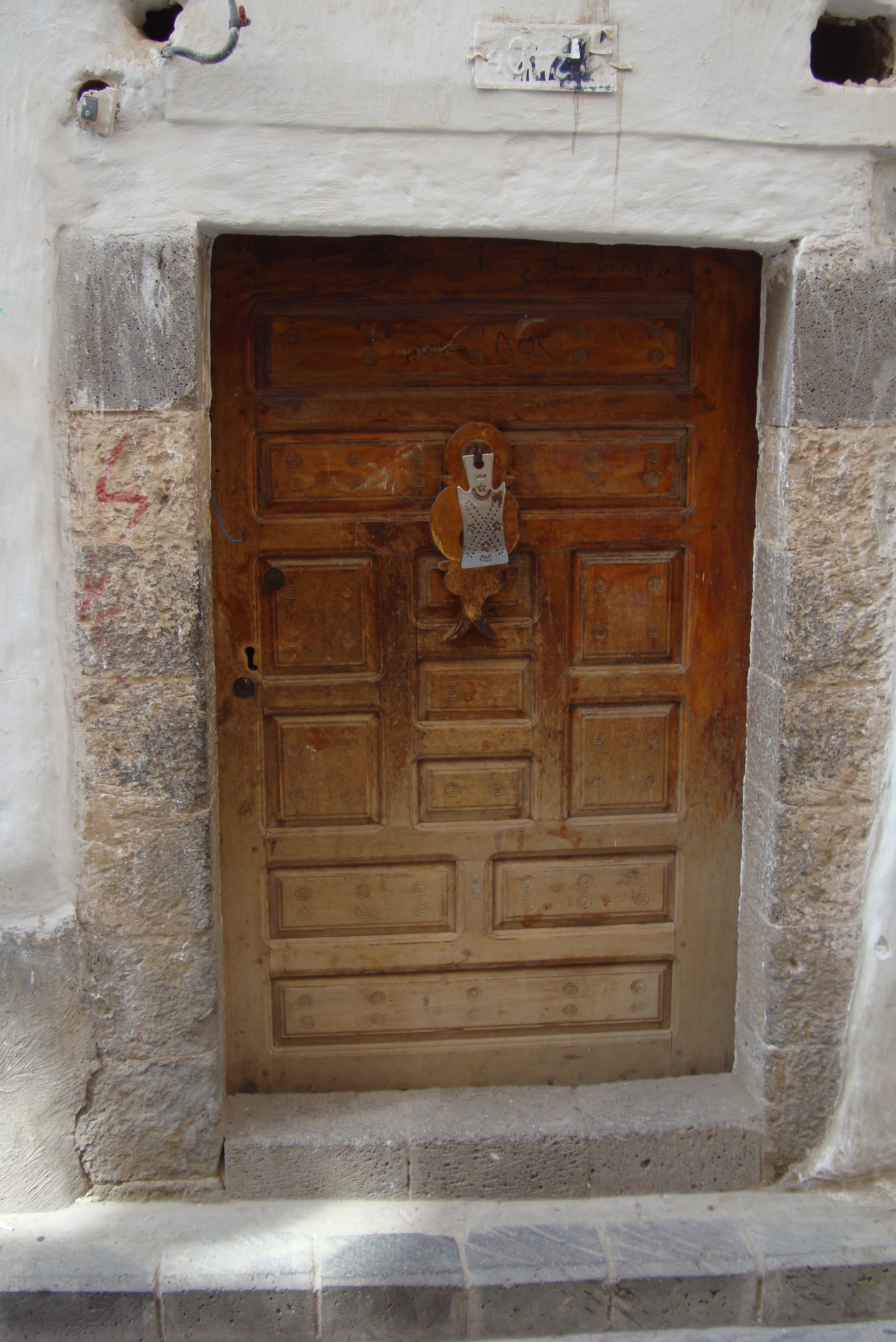 Stunning Doorway in Sanaa, Yemen Featuring a Silver Knocker and Starry Design