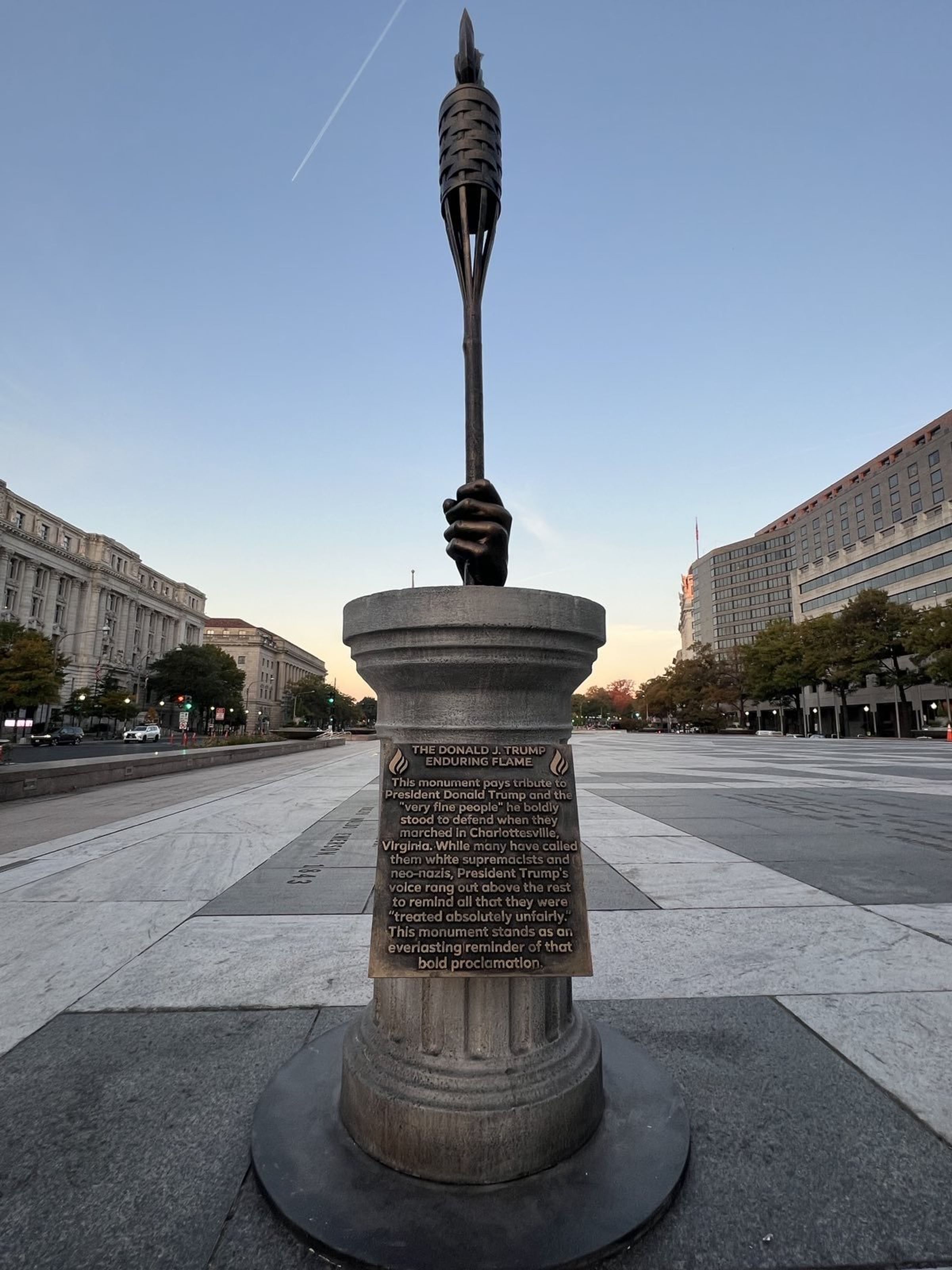 Trump Standing Strong by the Enduring Flame Monument