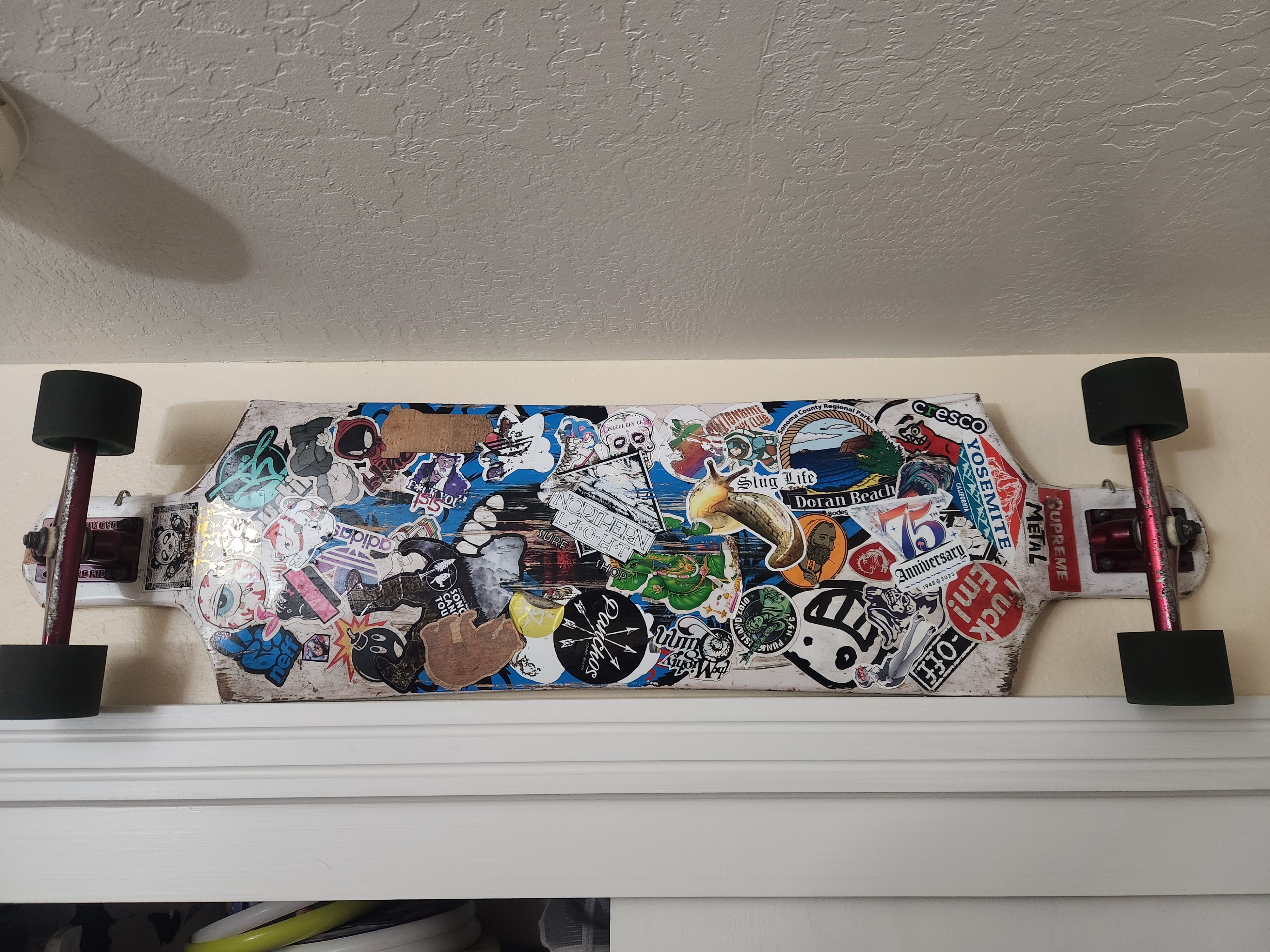 A Longboard Covered in Sticker Chaos