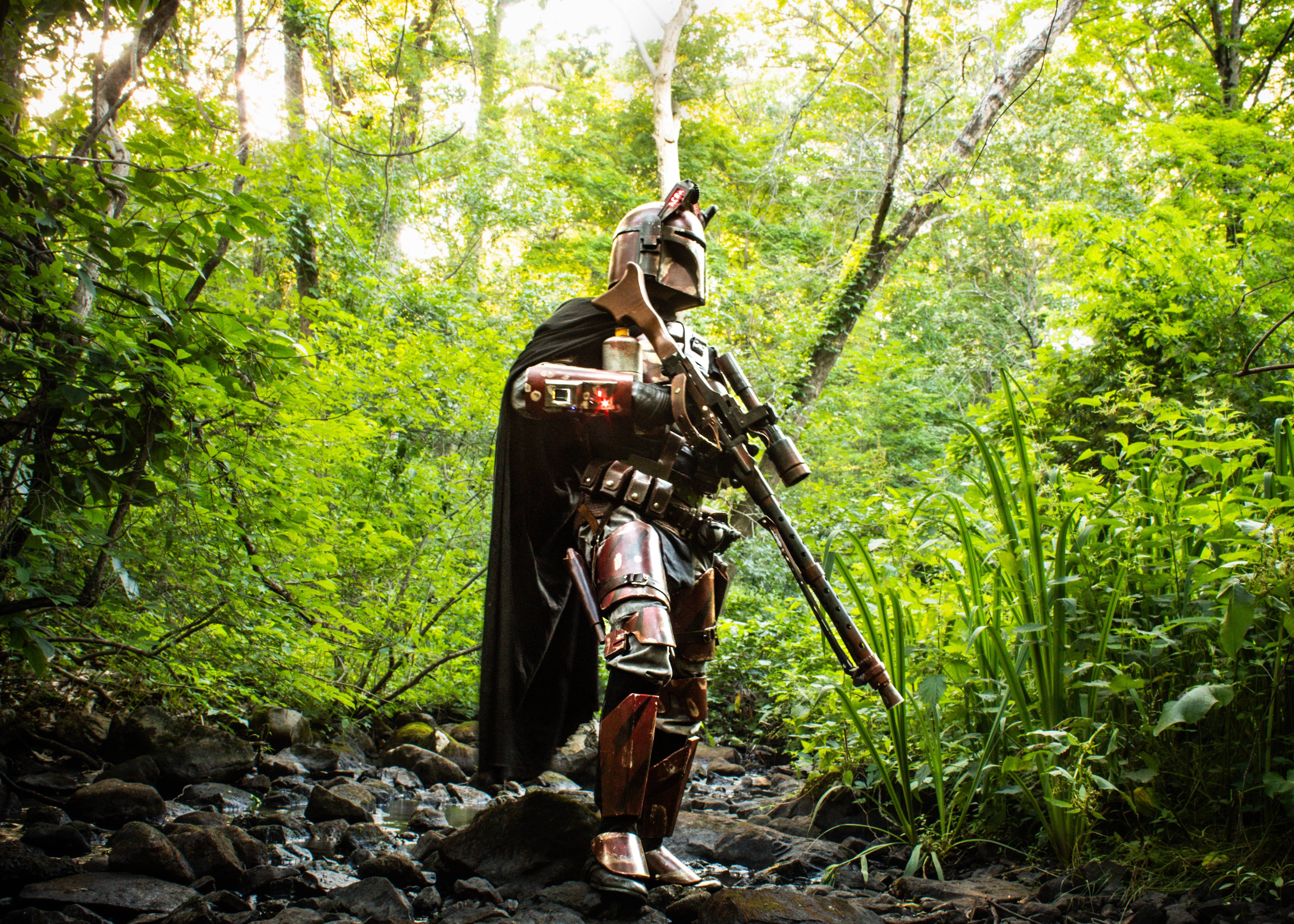 The Mandalorian exploring the depths of the forest