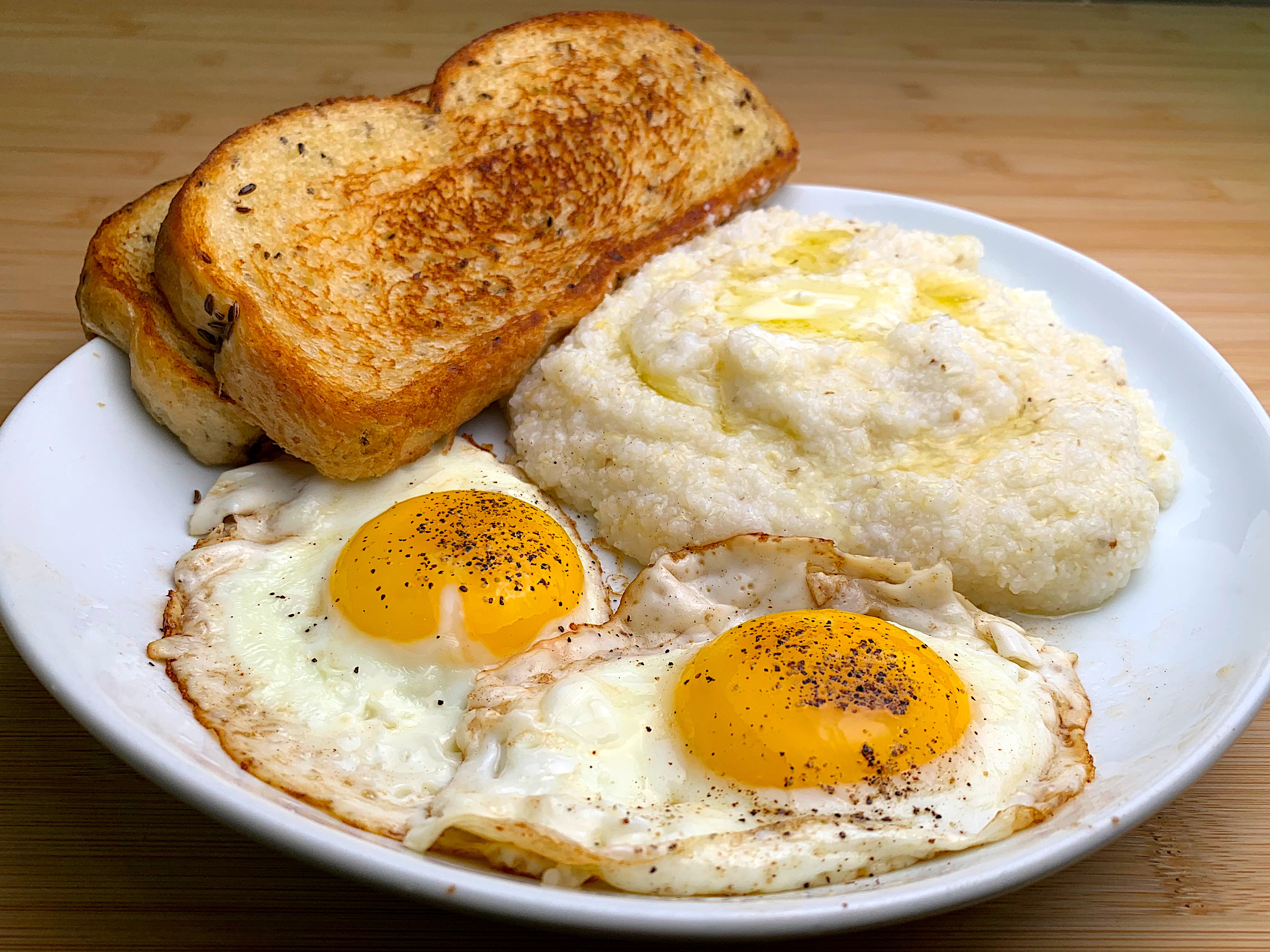 A Delicious Breakfast of Eggs and Grits with Toasted Rye