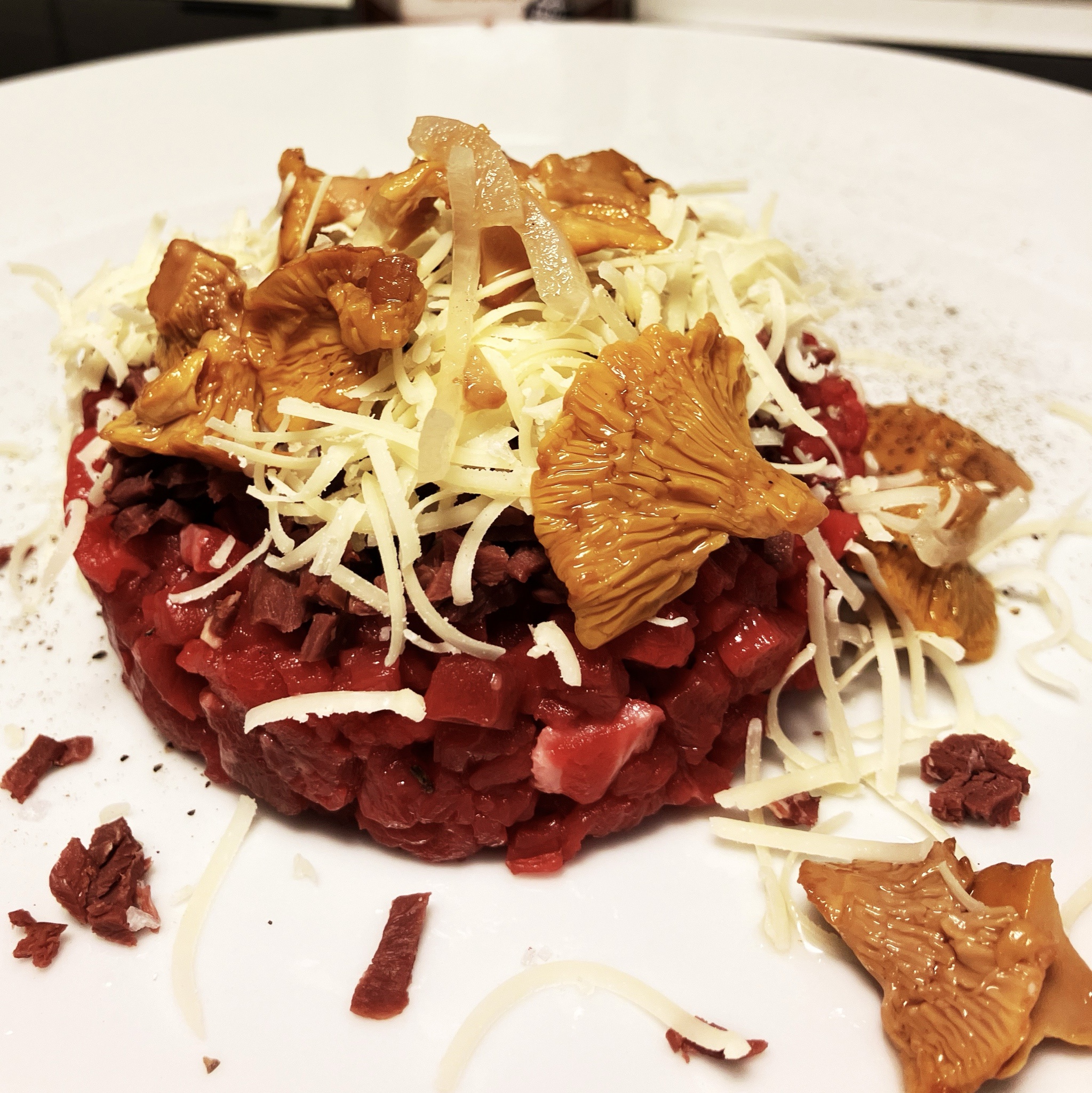 A Gourmet Delight: Tartar, Pickled Chanterelles, Smoked Reindeer Heart, and Gruyere