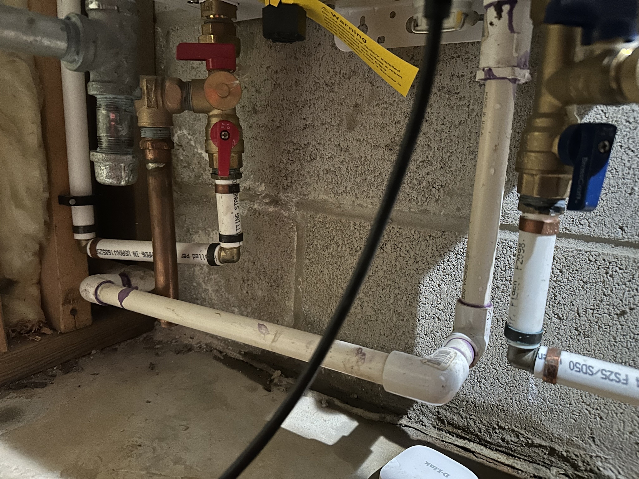 What could be causing this mysterious leak from my Navien tankless system?