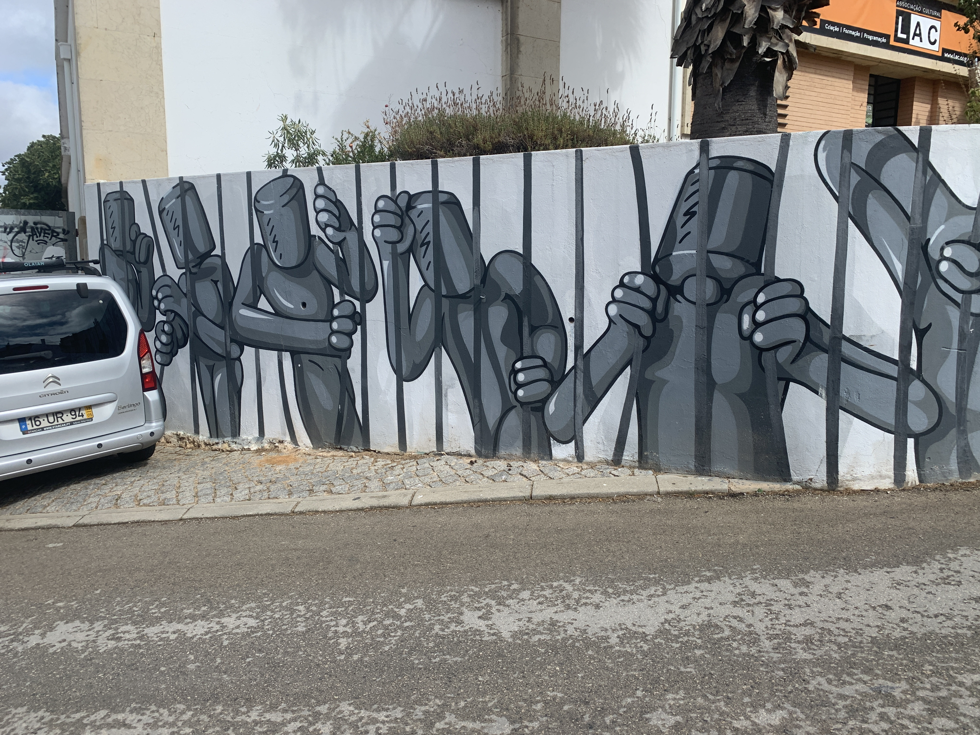 Exploring the captivating street art of Lagos, Portugal, captured behind bars.
