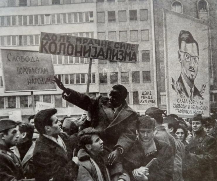 Throwback to 1961: A massive protest in Belgrade against the murder of Patrice Lumumba, featuring powerful signs like 'Down with the Dark Forces of Colonialism' and 'Freedom for Enslaved People'