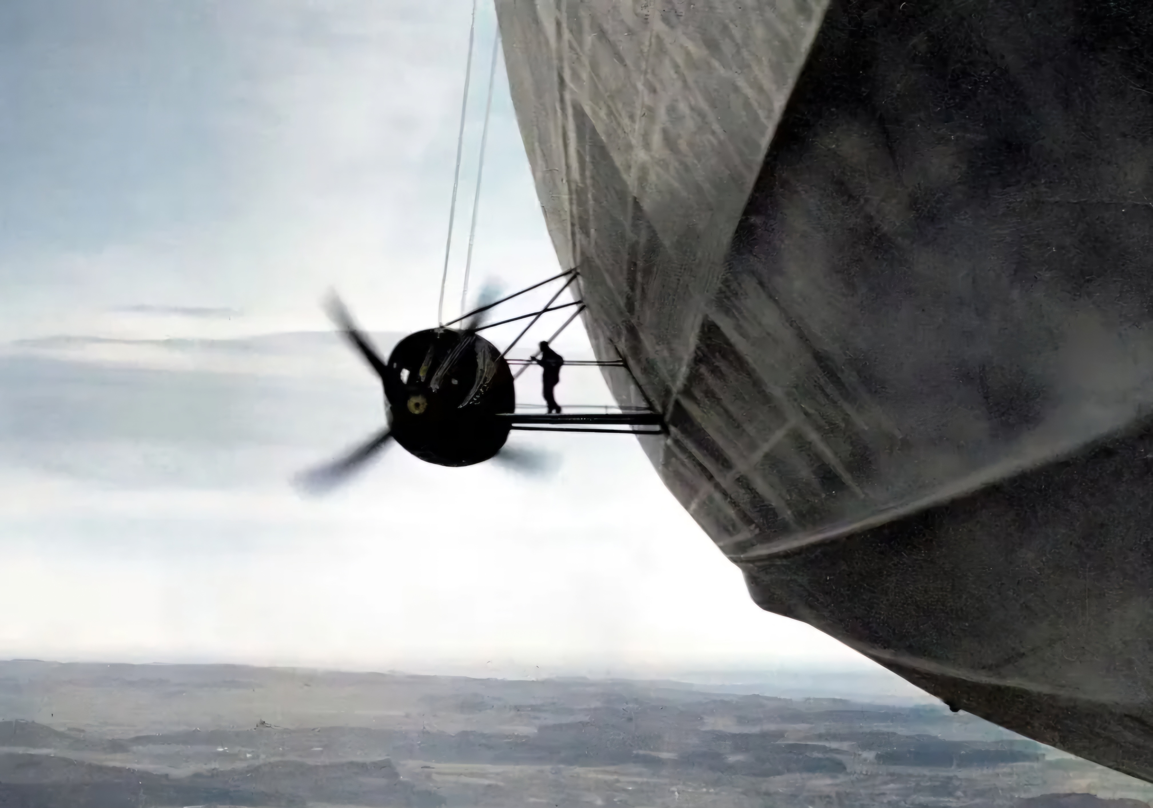 An engineer meticulously inspecting the engines of an airship in 1936