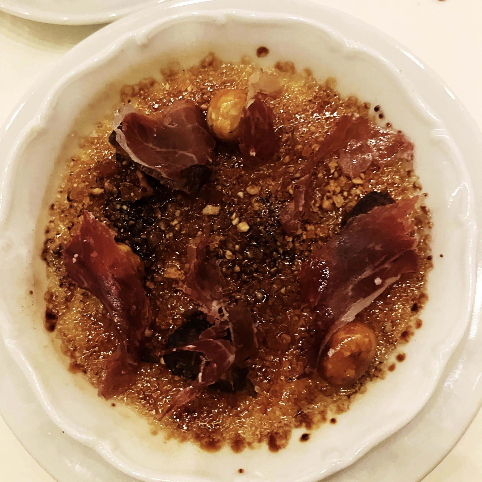 Brulée with Dates, Hazelnuts, and Jamón Ibérico: A Culinary Delight