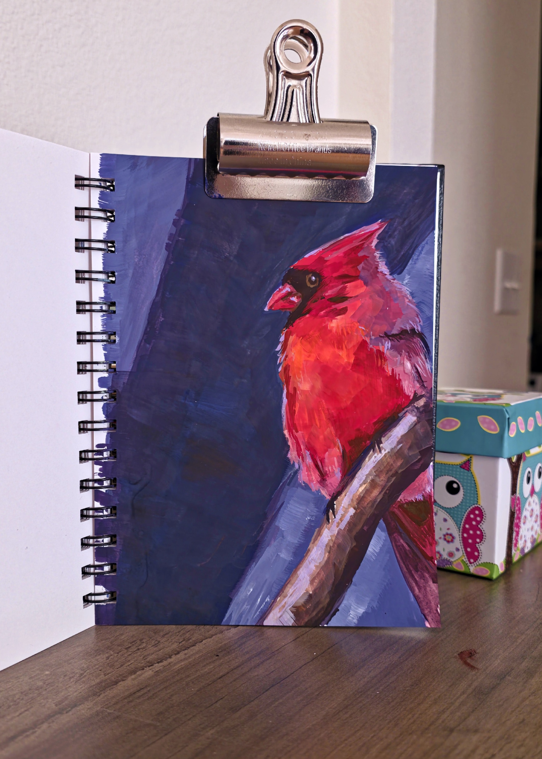 A vibrant gouache study of a red cardinal