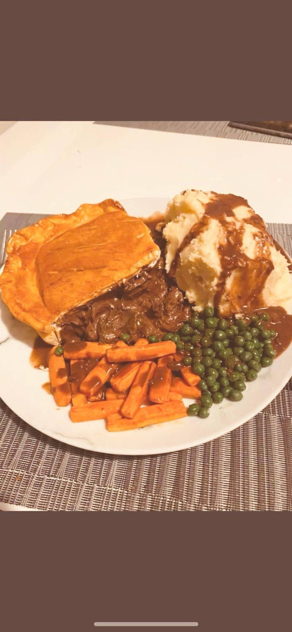 Delicious Steak and Ale Pie Served with Peas, Carrots, and Creamy Mash