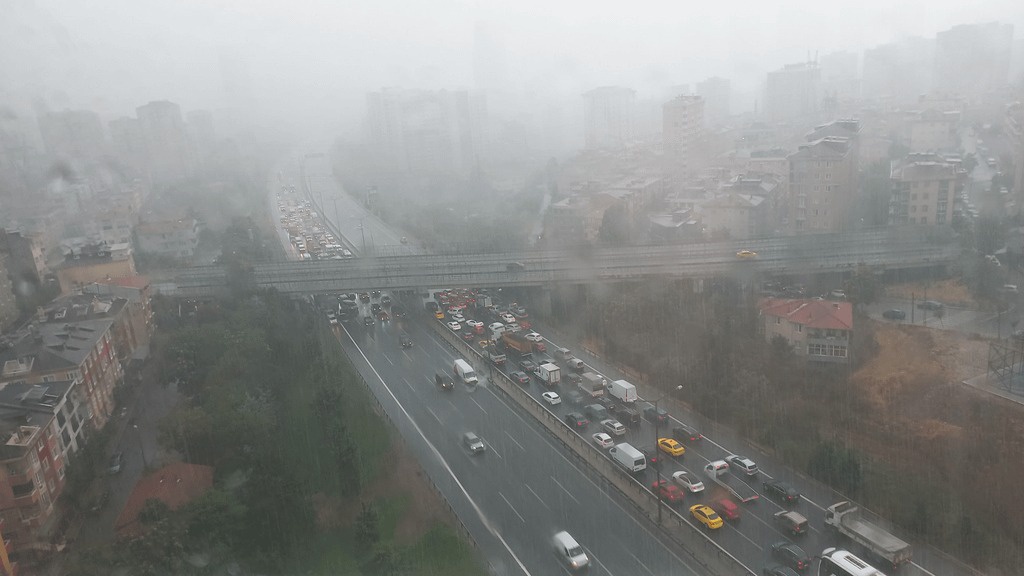 Drivers taking cover under a bridge to protect their cars from hail damage