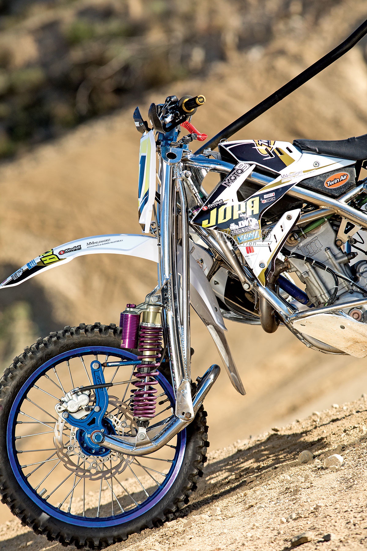 Innovative leading link front suspension for sidecar motocross bikes.