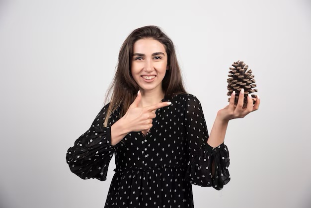 A stock photo capturing a woman and her pinecone moment