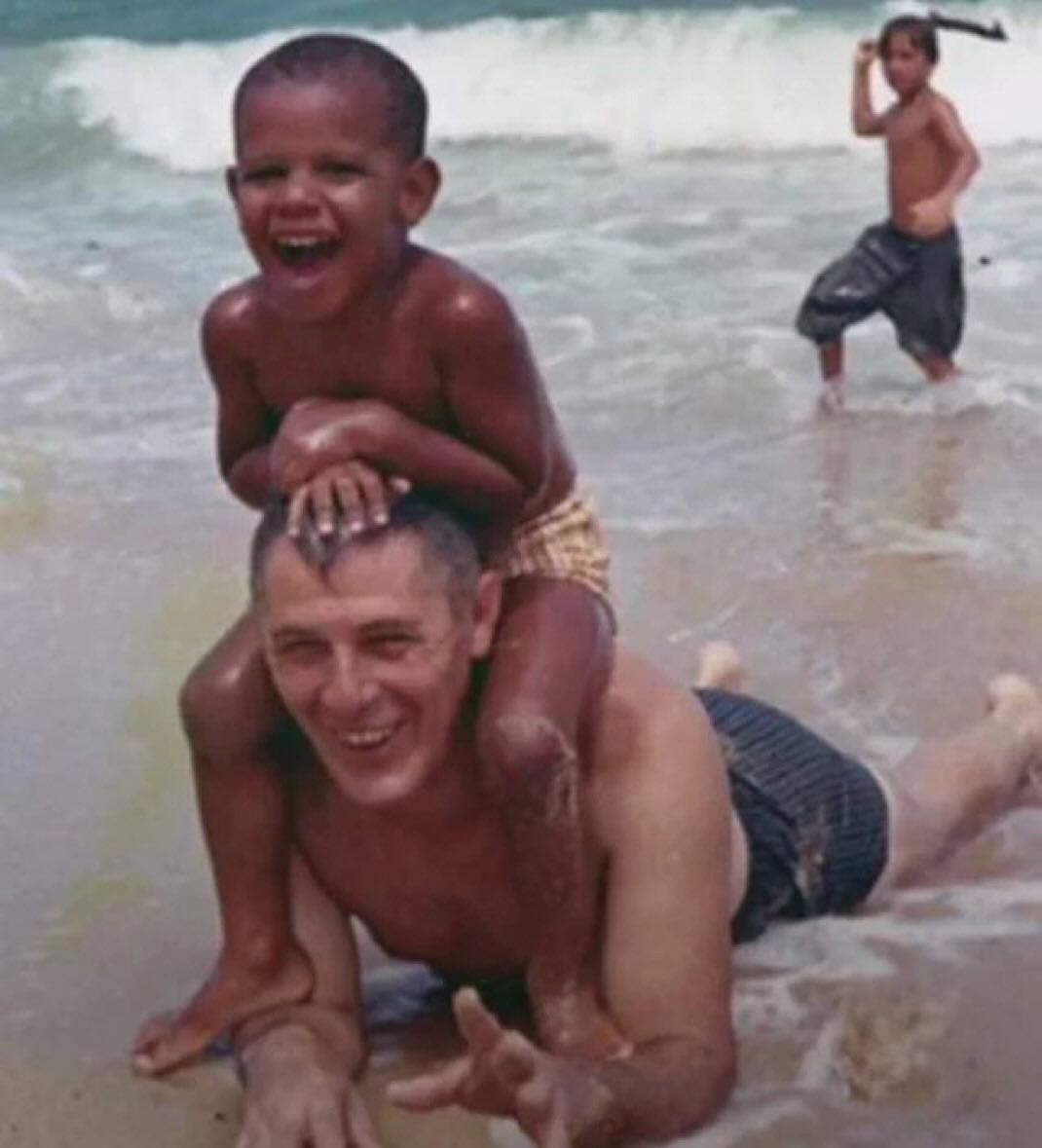 A young Barack Obama enjoying a beach day with his grandfather in 1963.