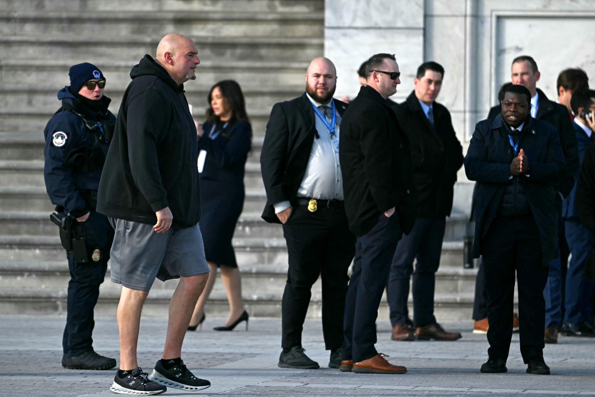 Trump shifts his ceremony indoors to escape the chill, while Sen. John Fetterman shows up in a hoodie and shorts