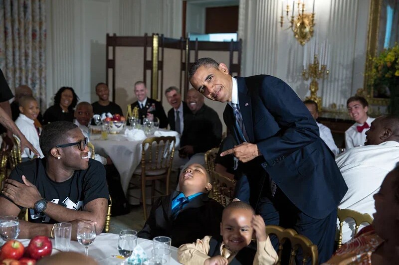 A kid dozing off at a White House event while Obama captures the moment